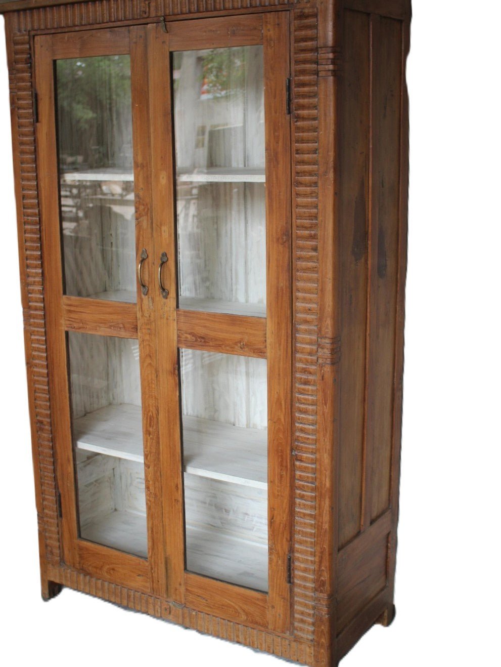 Glass front teak cabinet with hand carved fluting, for storing books, kitchenware, linens or tableware