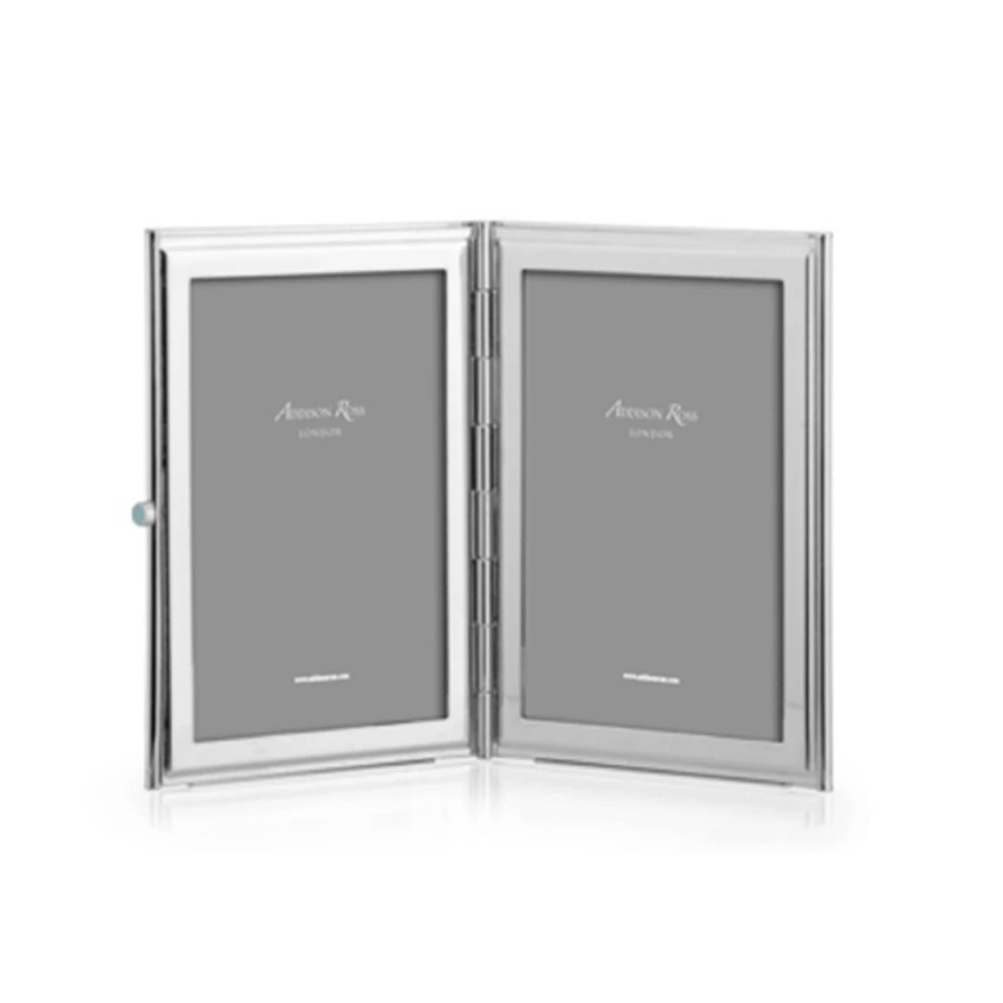 White enamel travel double frame by Addison Ross, open to show two 2 x 3 inch portrait slots