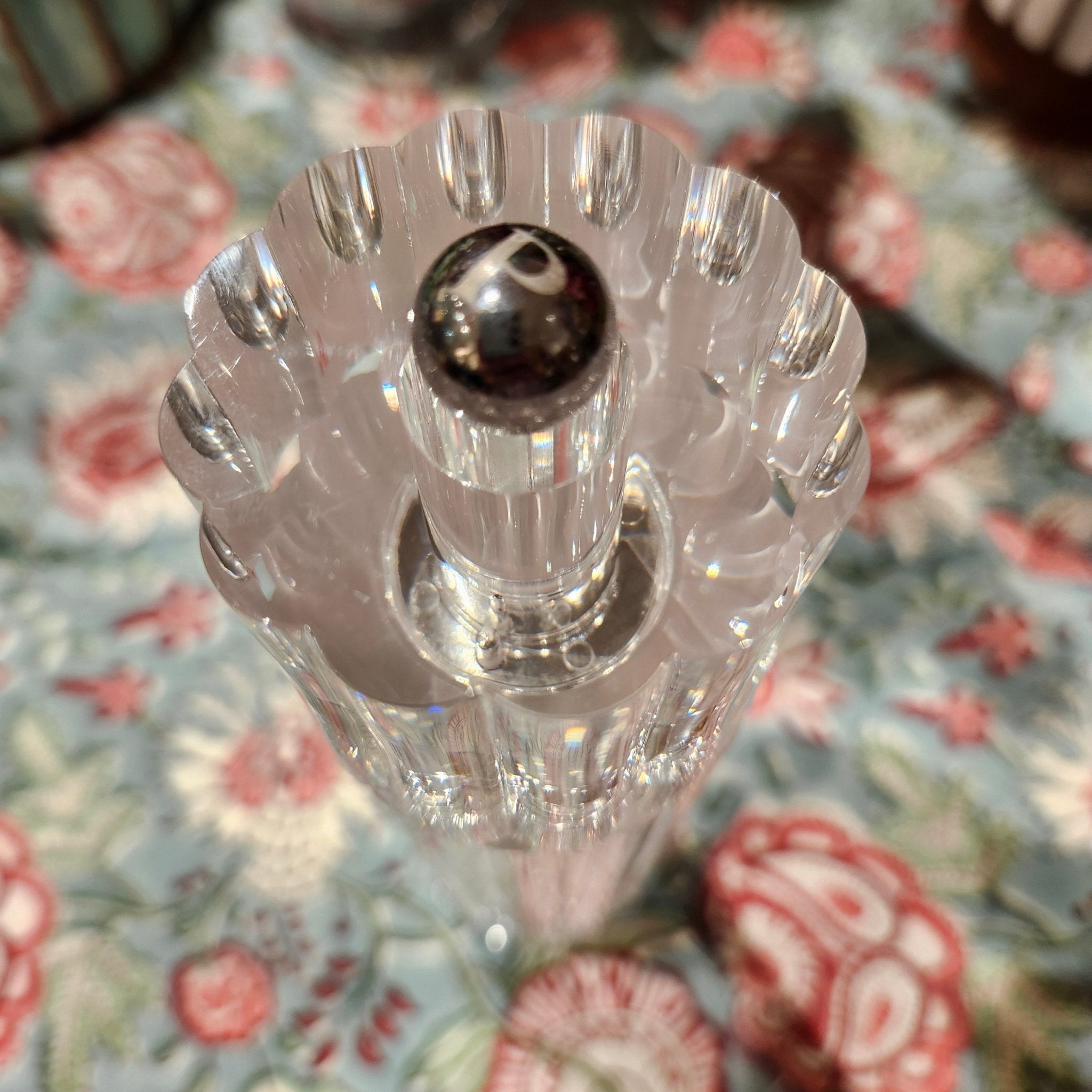 Clear acrylic pepper mill on a floral-patterned table cloth