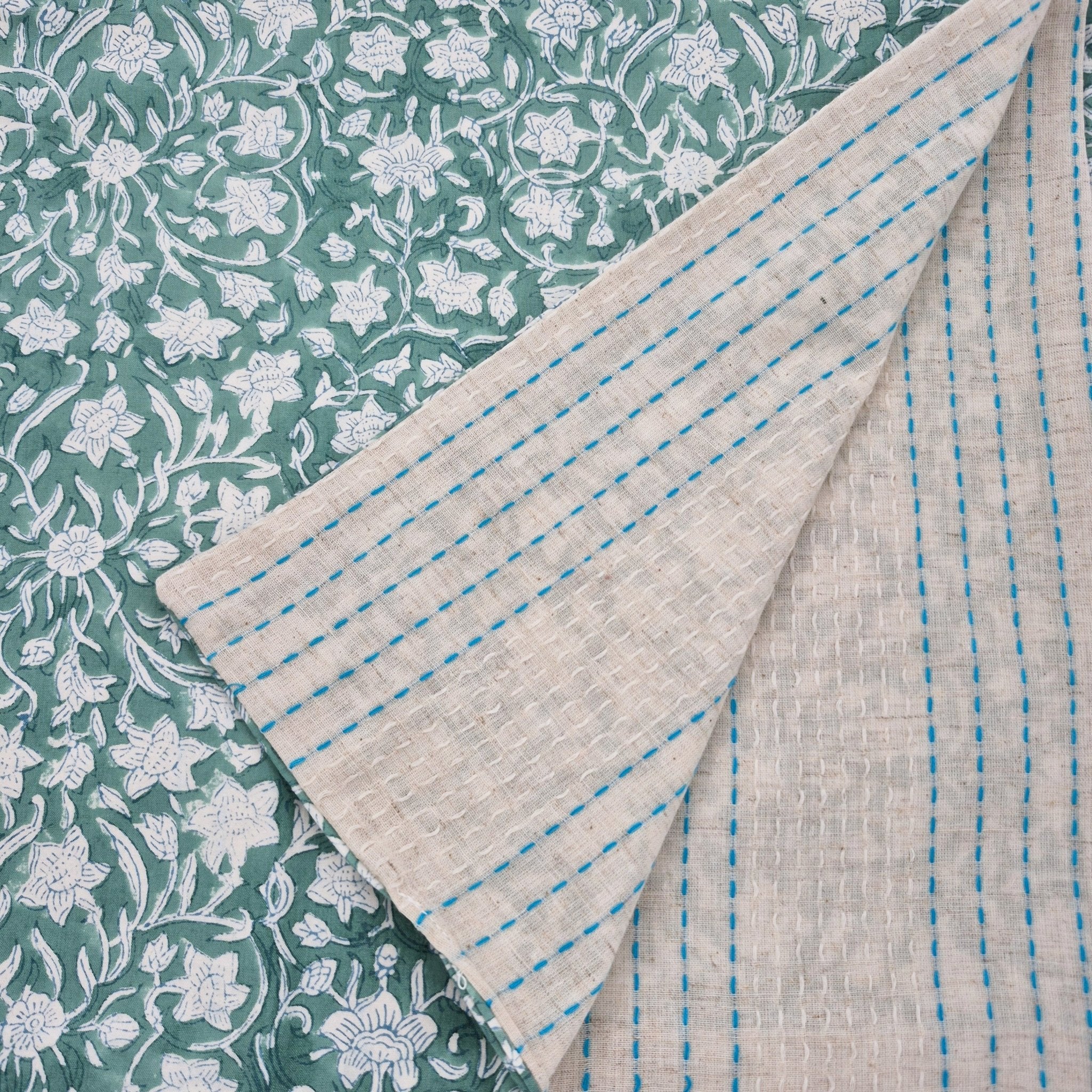Reversible table runner with block print floral green on one side and woven cotton stripes on the other