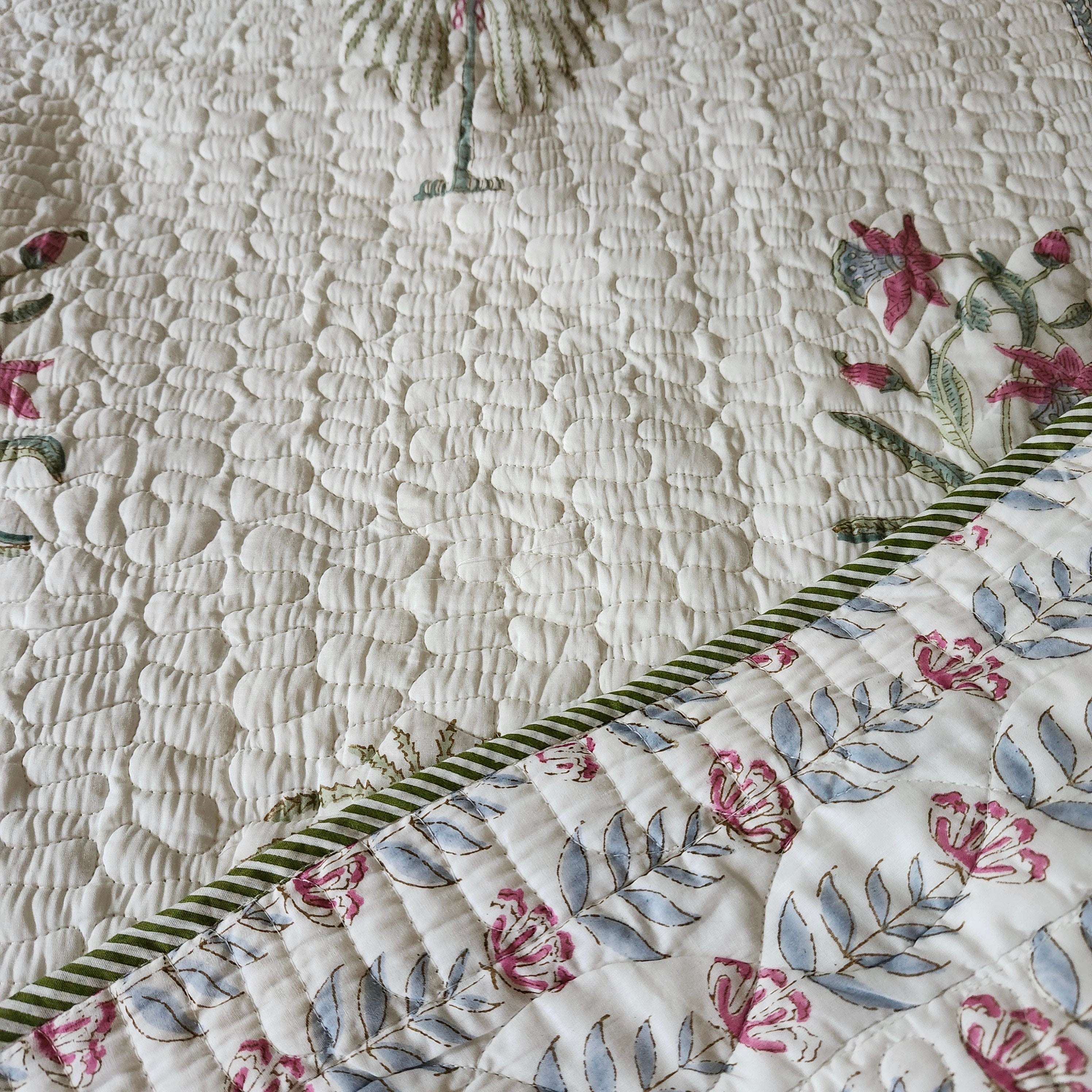Quilted palm and flower block-print bedspread in muted shades