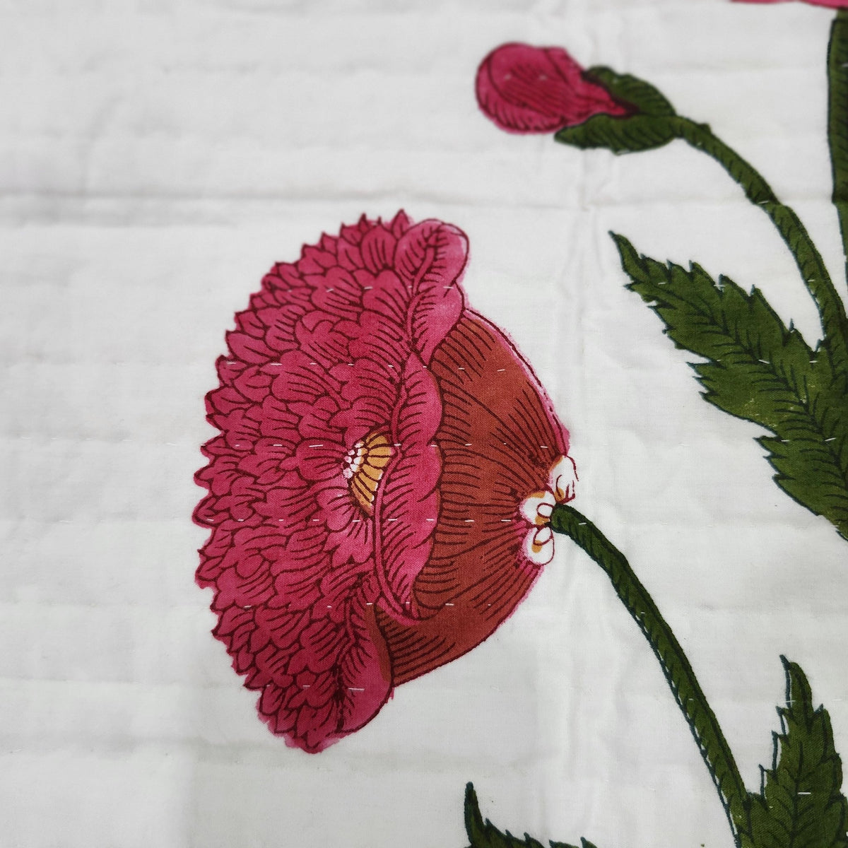 Reverse of the poppy bedspread, showing the green striped block print backing in 100 per cent cotton.