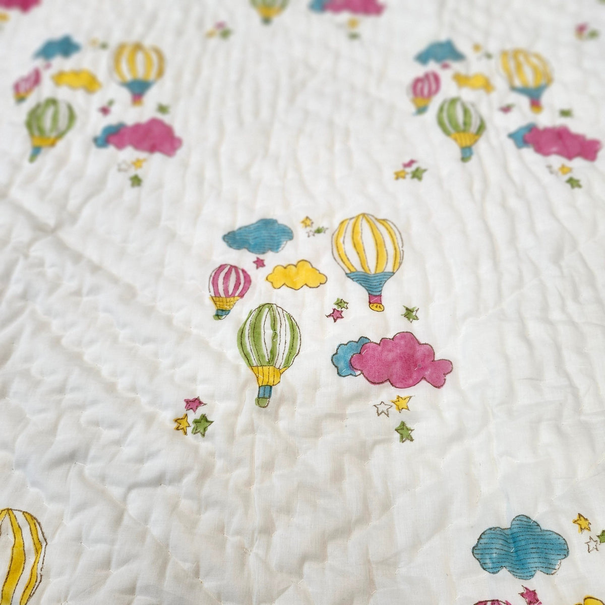 Colourful balloon block-print quilt for children, detail view