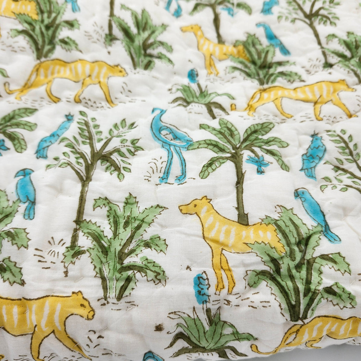 Reverse of the child's jungle block print quilt, a contrast chevron stripe pattern, so the quilt can be used either way up