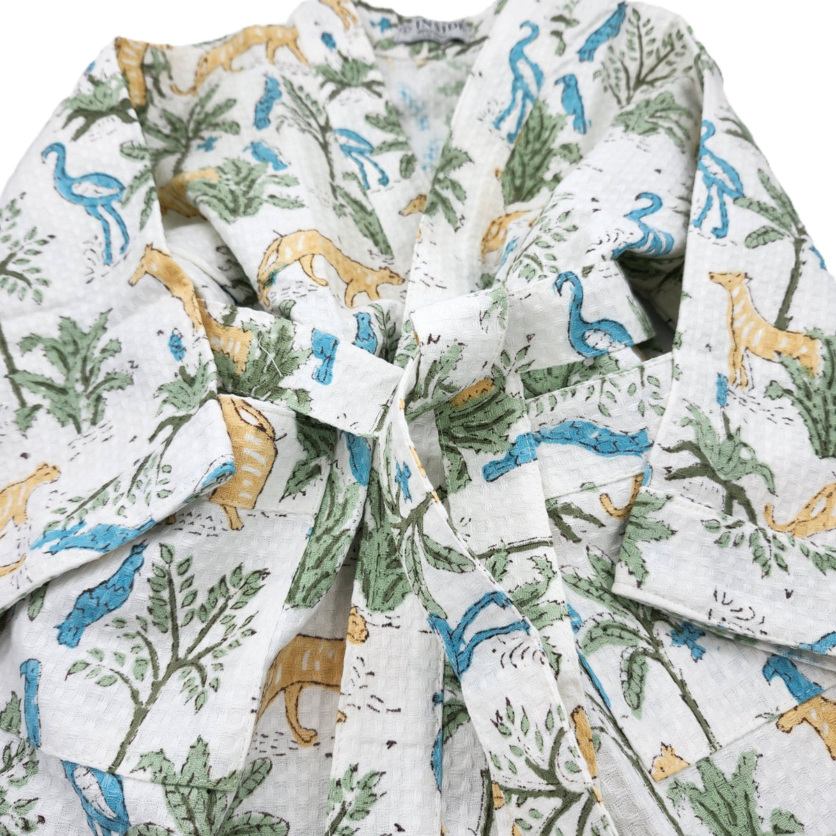 Alternative view of the jungle print child's bath robe in cotton waffle, showing a pocket and belt, machine washable warm