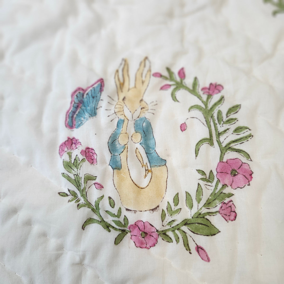 Child's block-print organic cotton quilt with an adorable Peter Rabbit print, machine washable
