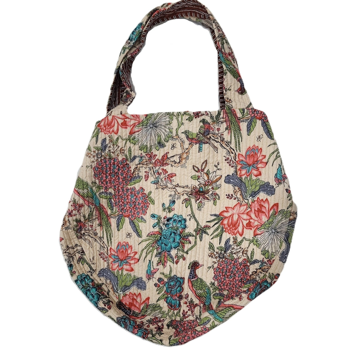 Styled view of the block print bag, which has a contrast lining and an internal zippered pocket.
