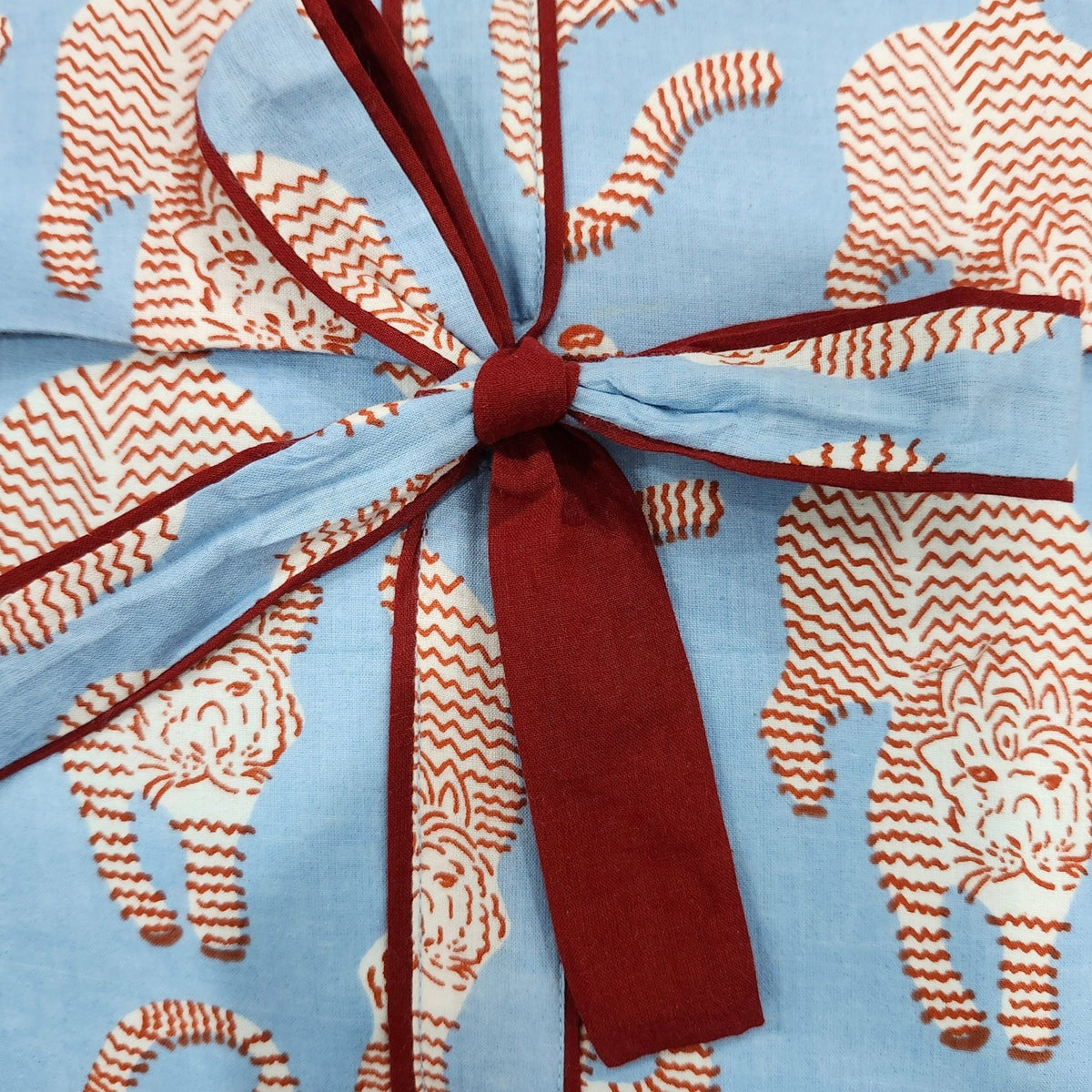 Tiger print pyjamas in a red colourway, supplied in a matching envelope bag, 100 per cent cotton.