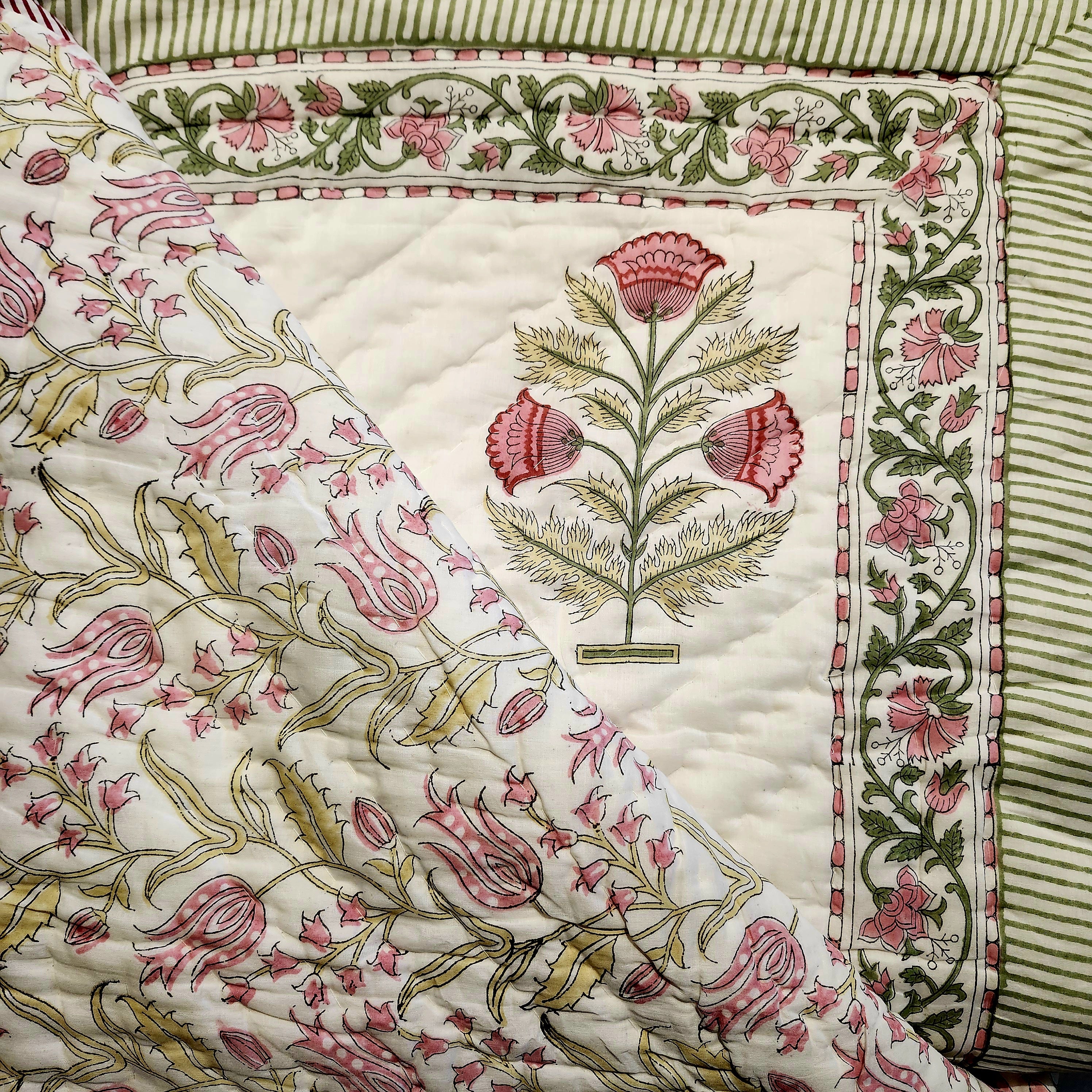 Single block-print quilt with pink tulips on white
