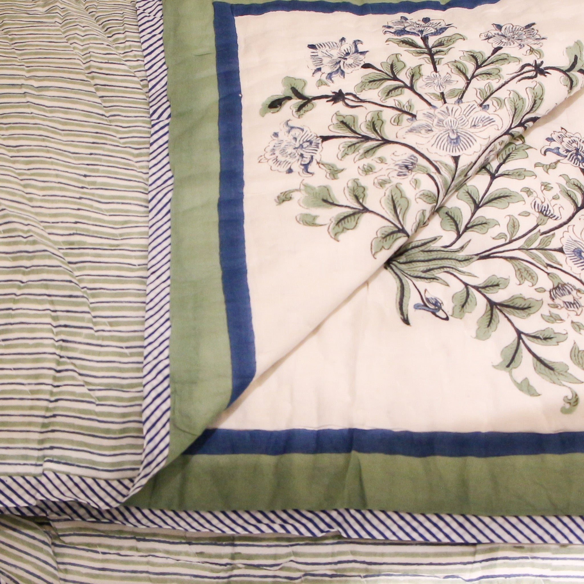 Reversible block-print quilt with blue flowers and lime stripes