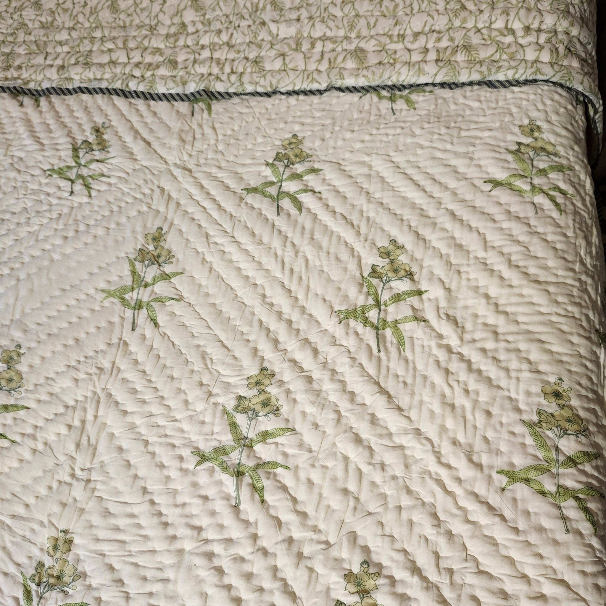 Block-print quilt, stems and leaves reverse in yellow tones