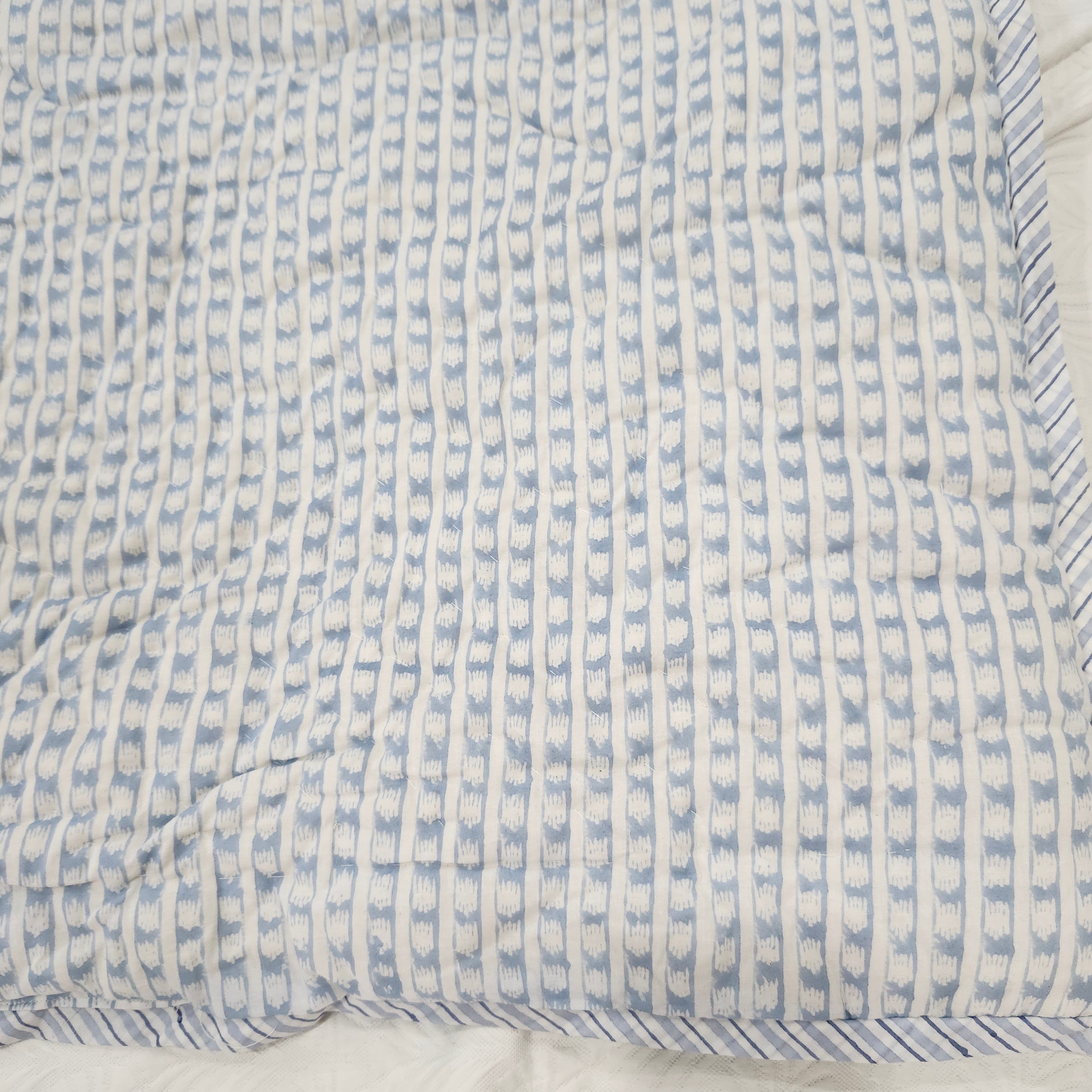 Block-print single quilt, blue and pale pink floral reverse