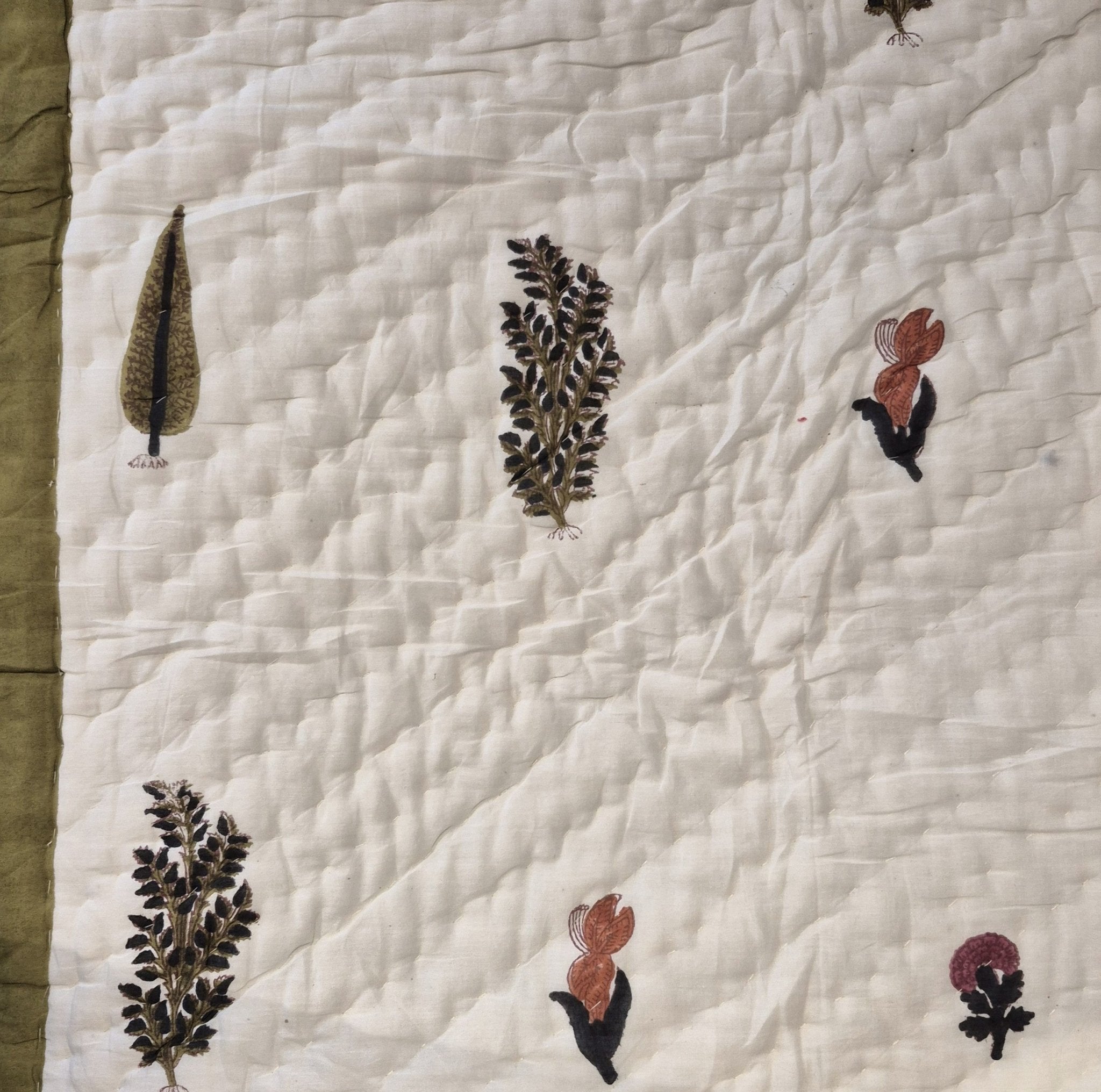 Single block-print quilt with cypress trees in olive