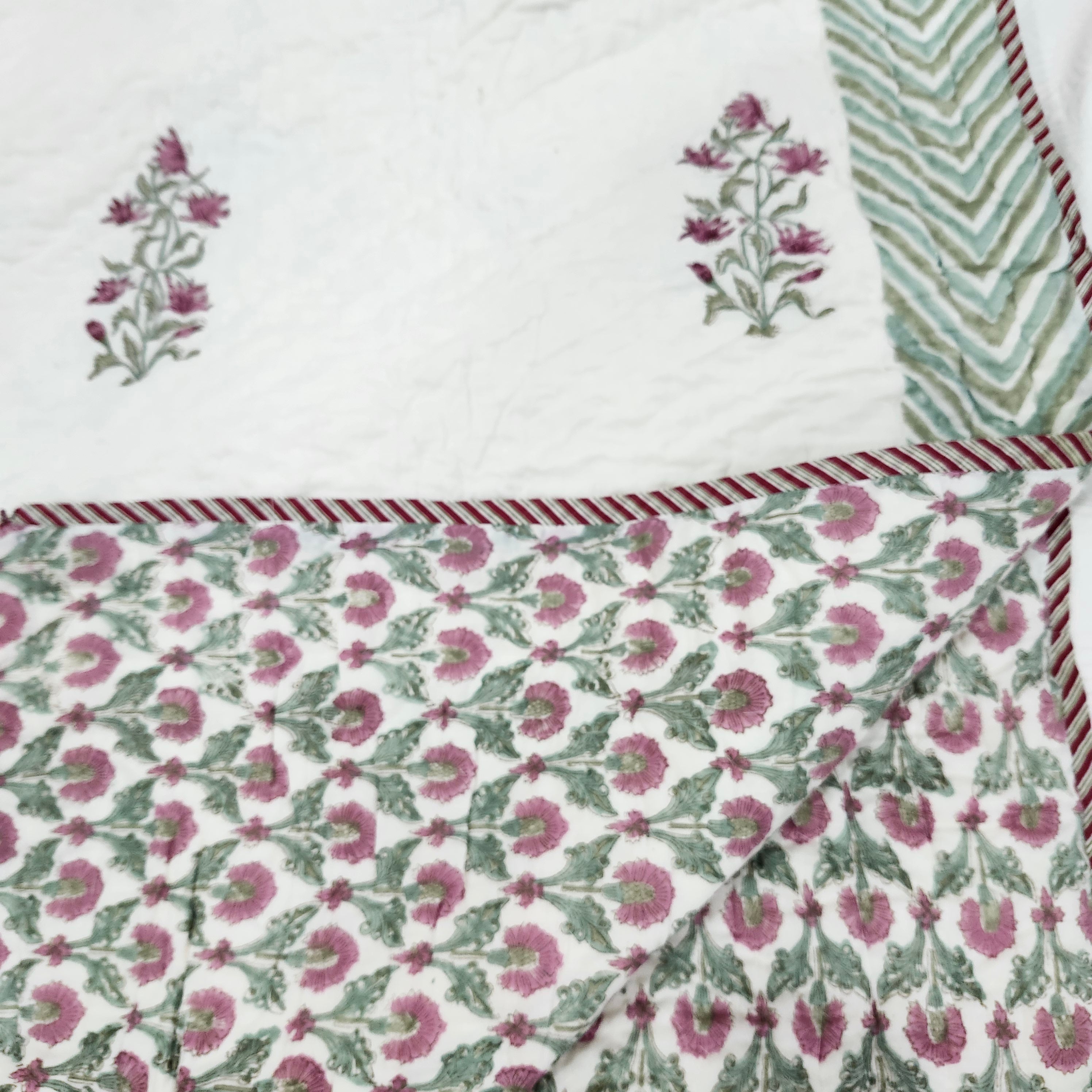 Floral reverse of the cream and pink block-print quilt