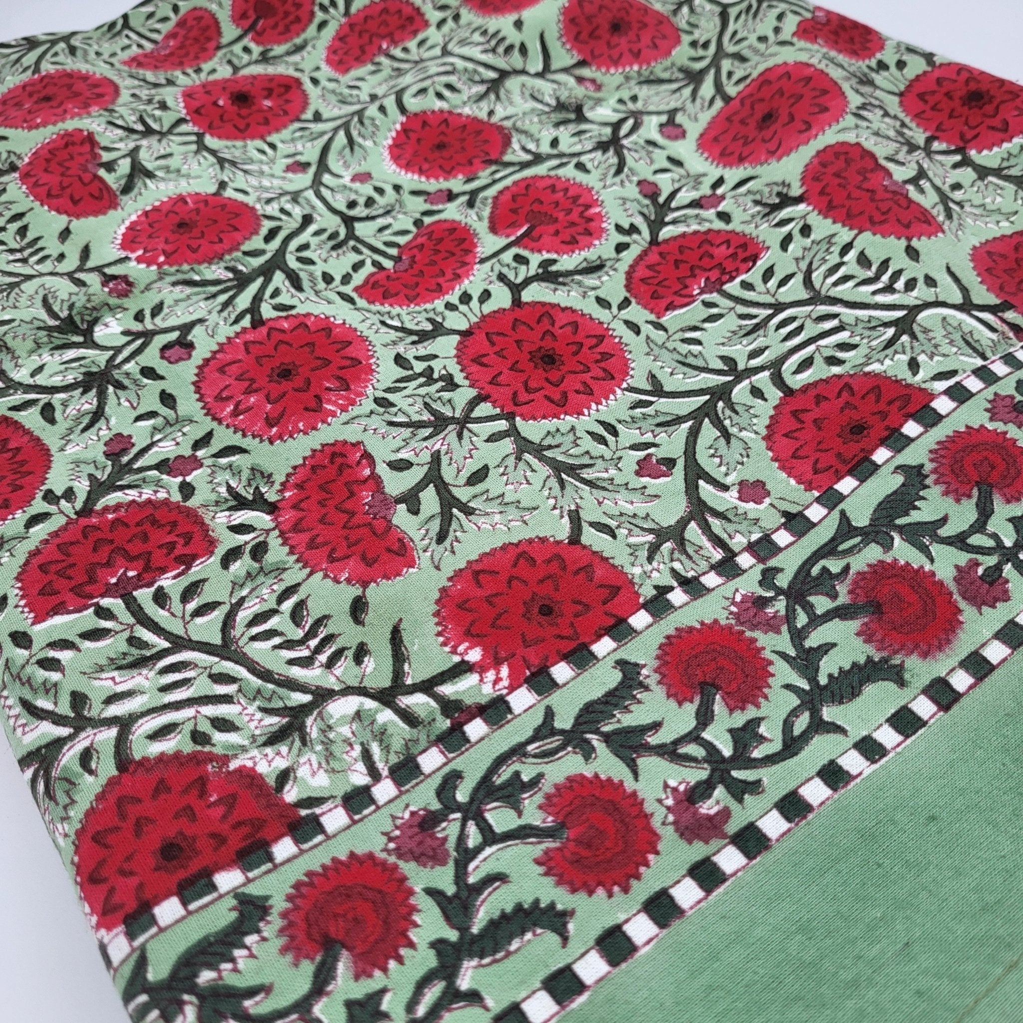 Block Print Tablecloth with red poppy pattern on a green background