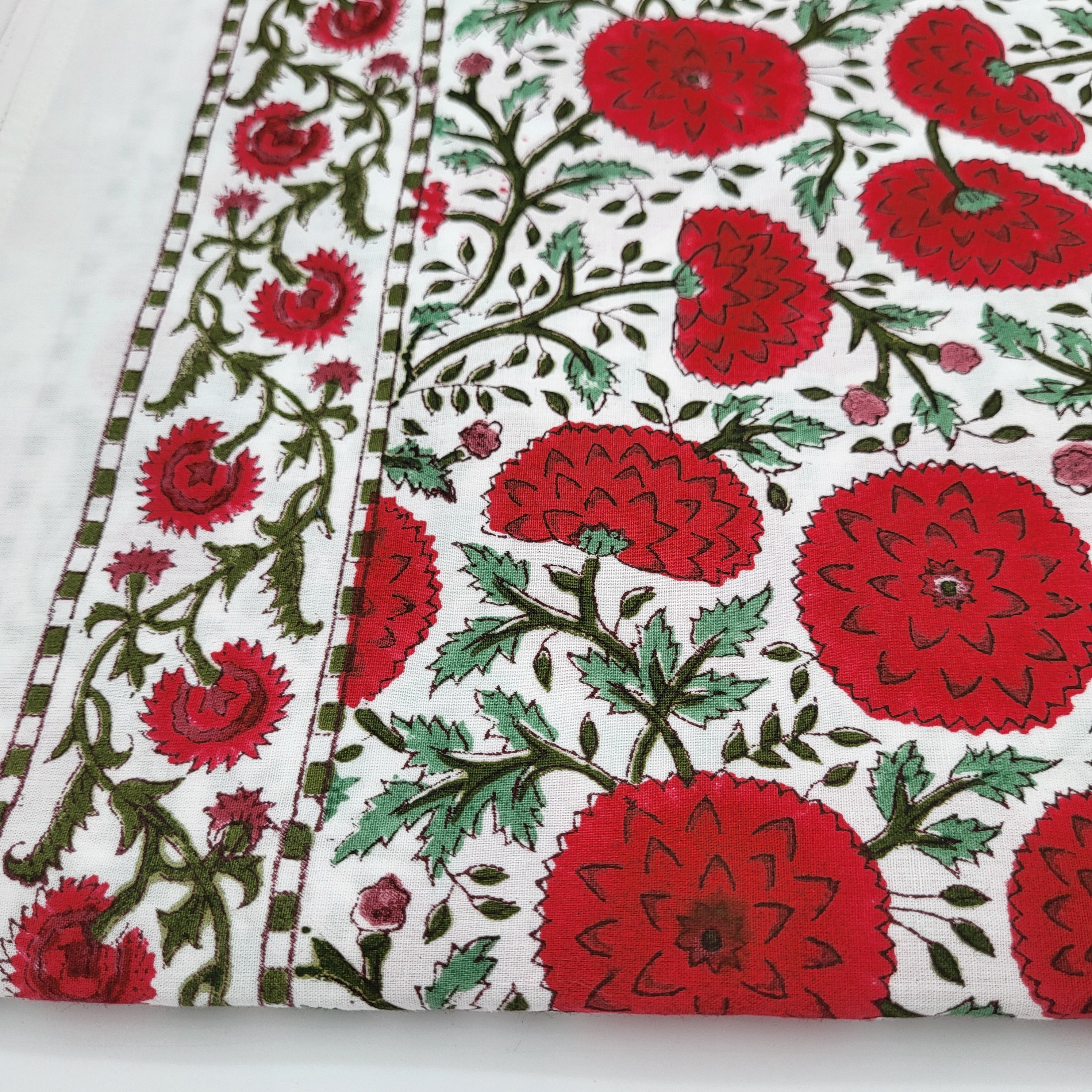 Block Print Tablecloth with red poppy flowers and green leaves on a white background