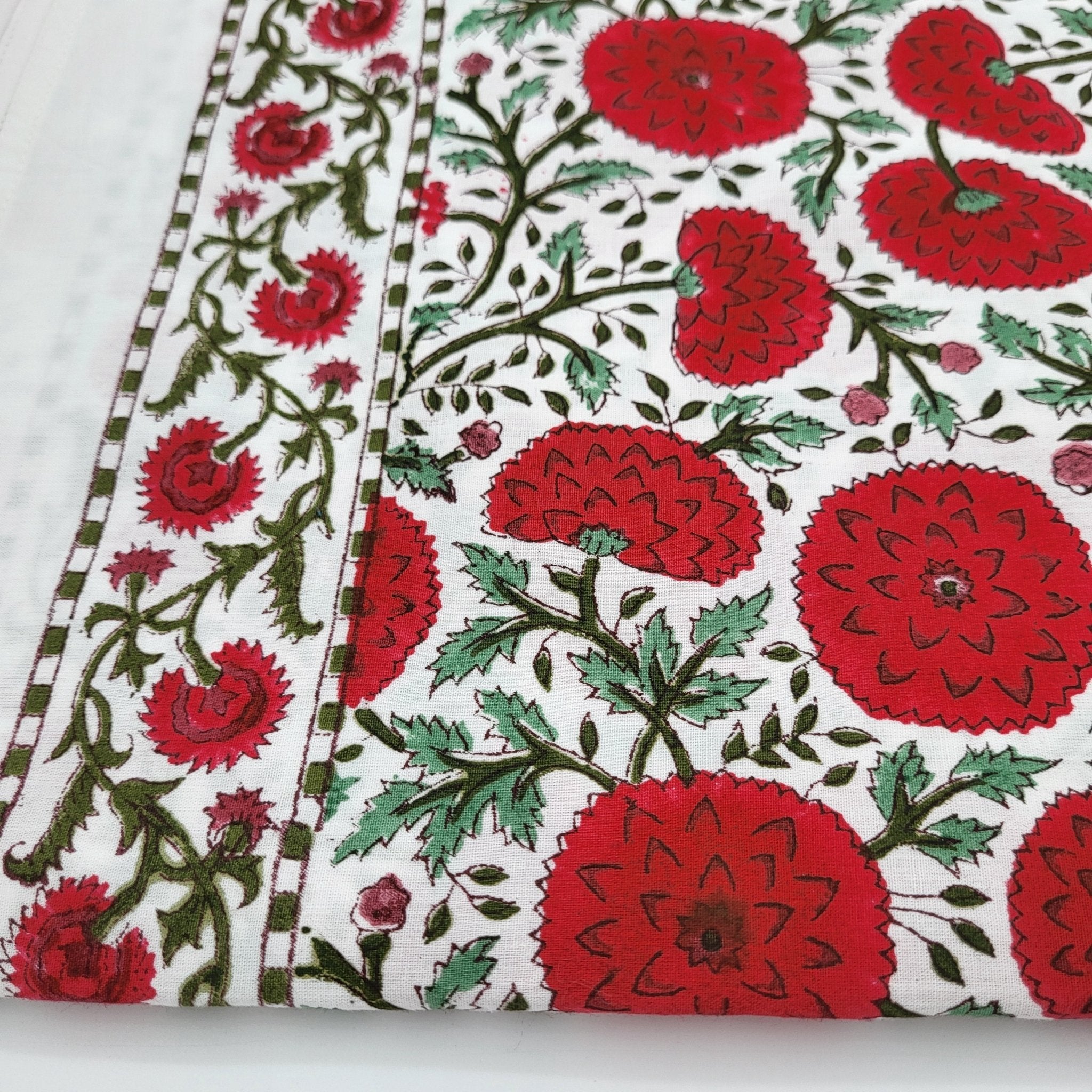 Block Print Tablecloth with red poppy flowers and green leaves on a white background