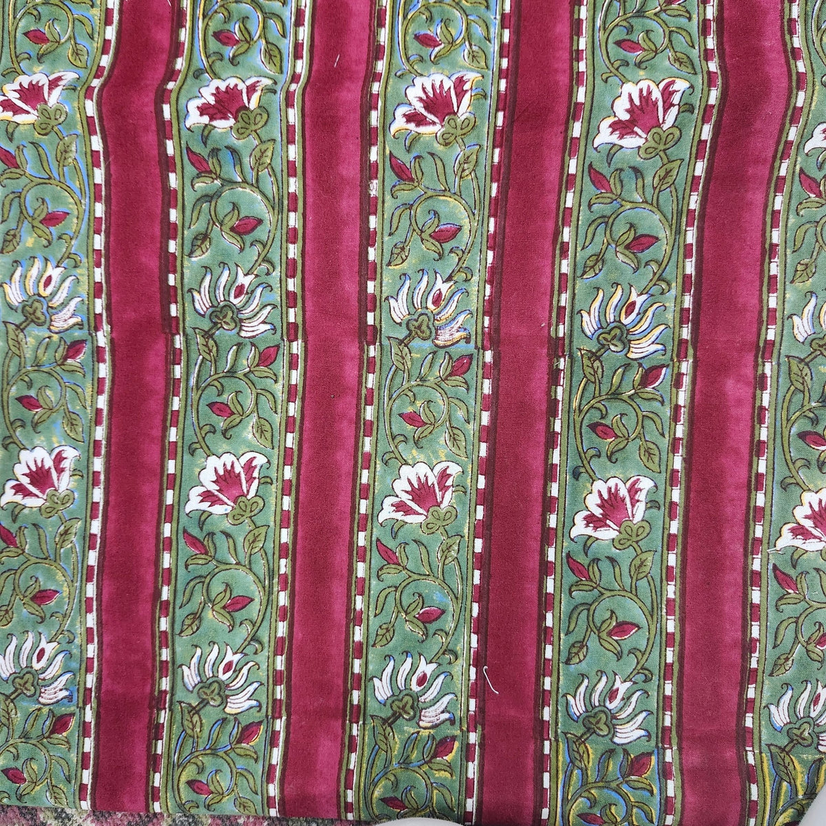 The festive stripe tablecloth laid for a celebration, 100 per cent cotton in burgundy red and green.