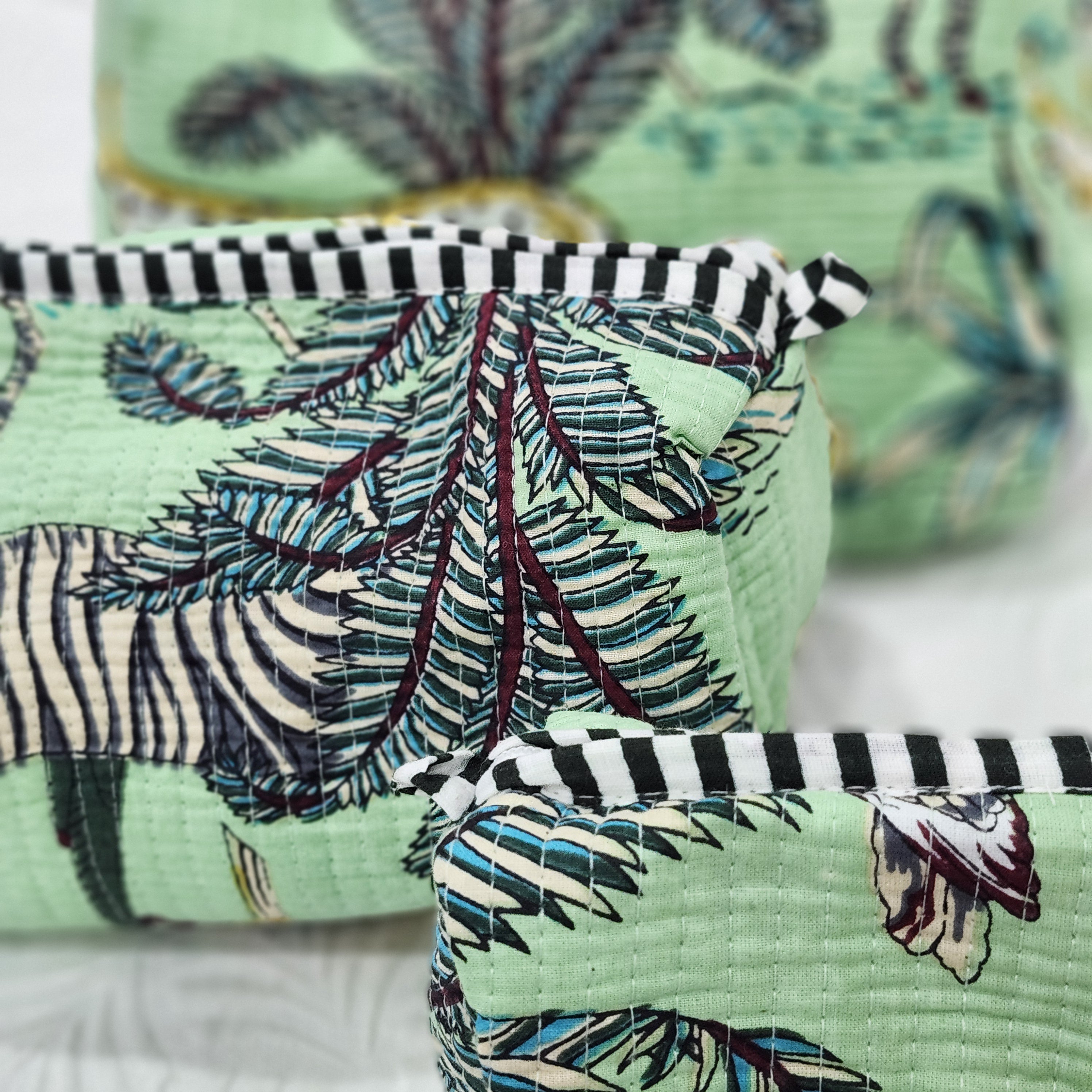 Safari block-print wash bag in green with animals and palms