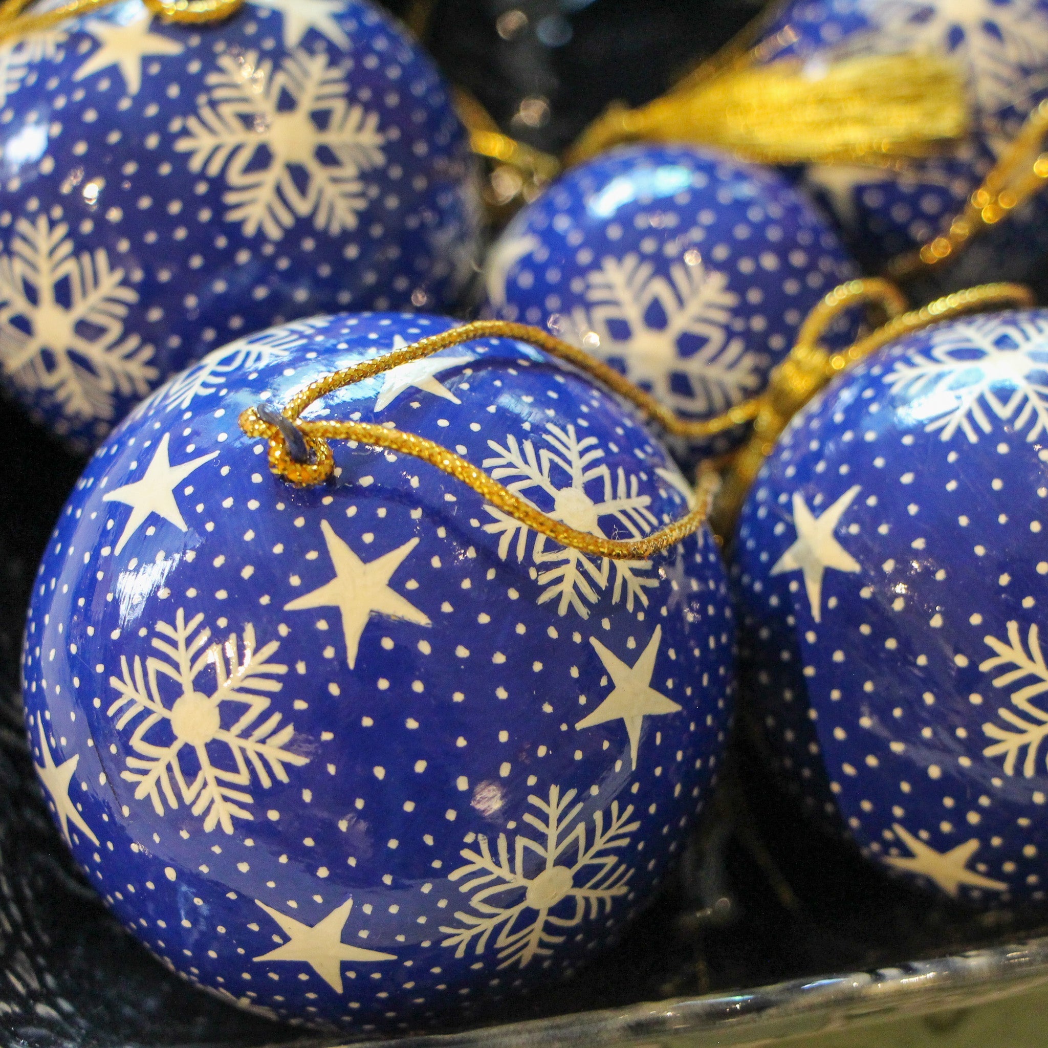 Blue papier-mache Christmas bauble hand-painted with a snowflake design