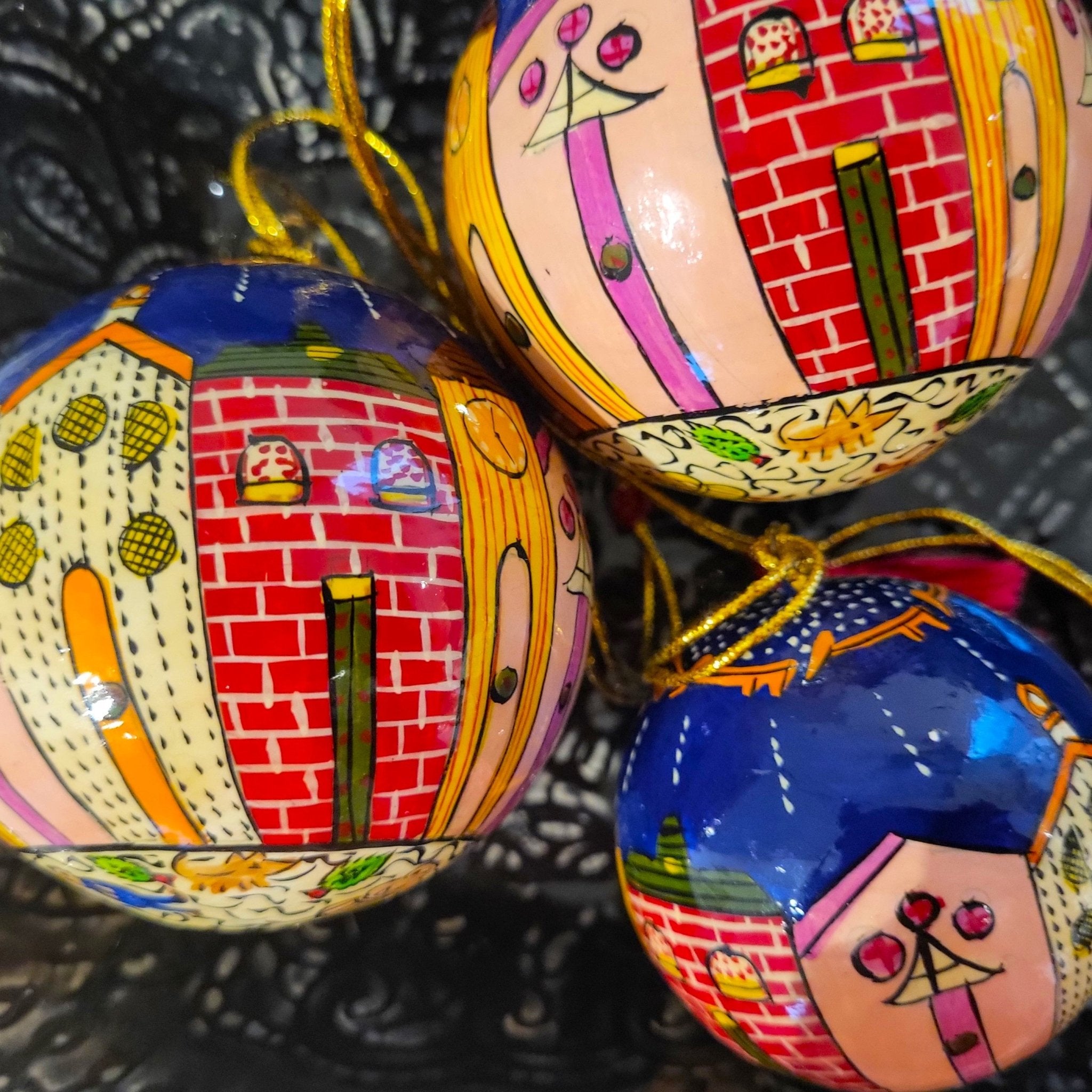 Papier-mache Christmas bauble hand-painted with whimsical winter houses