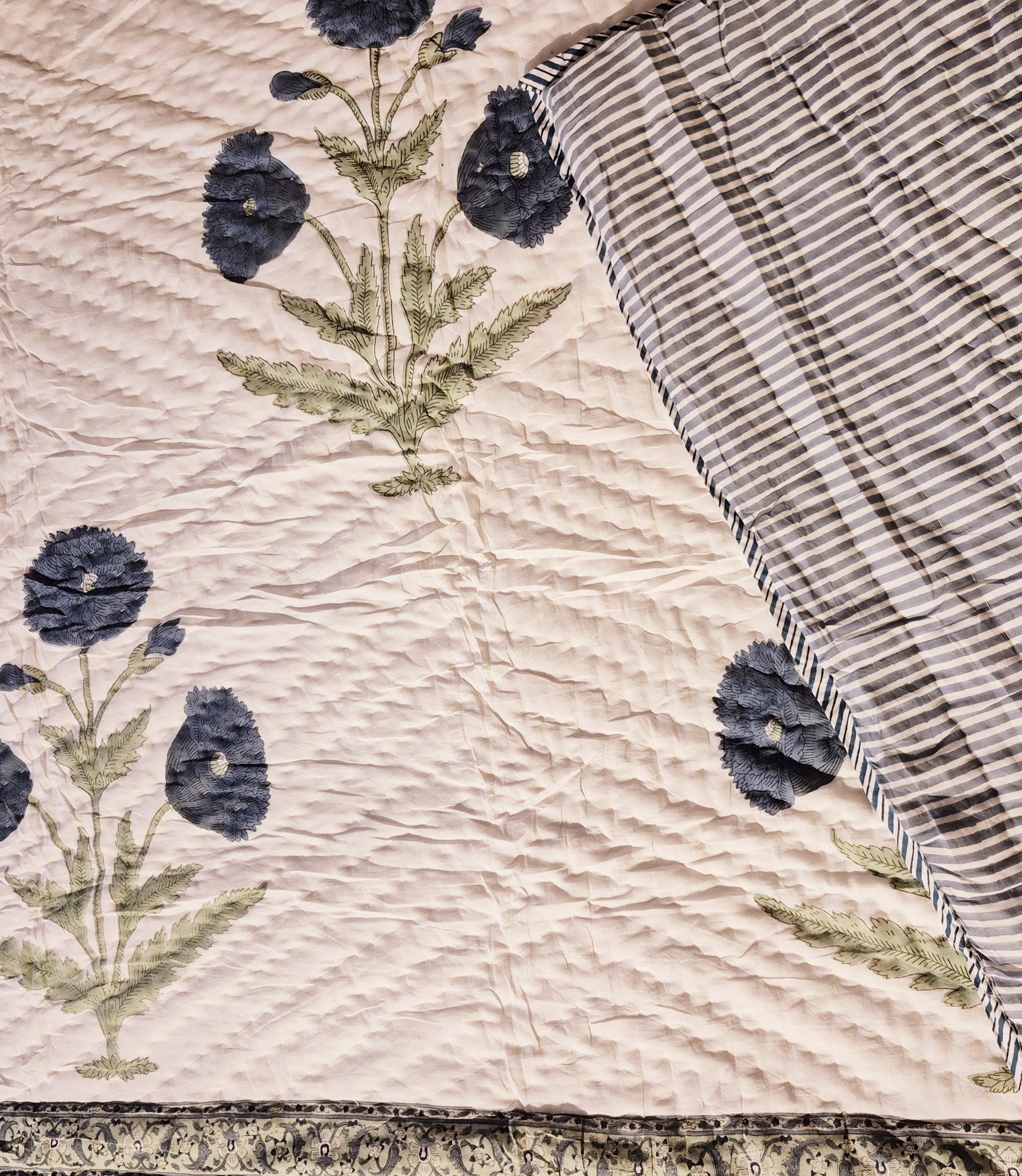 King block-print quilt with a blue poppy pattern on off-white