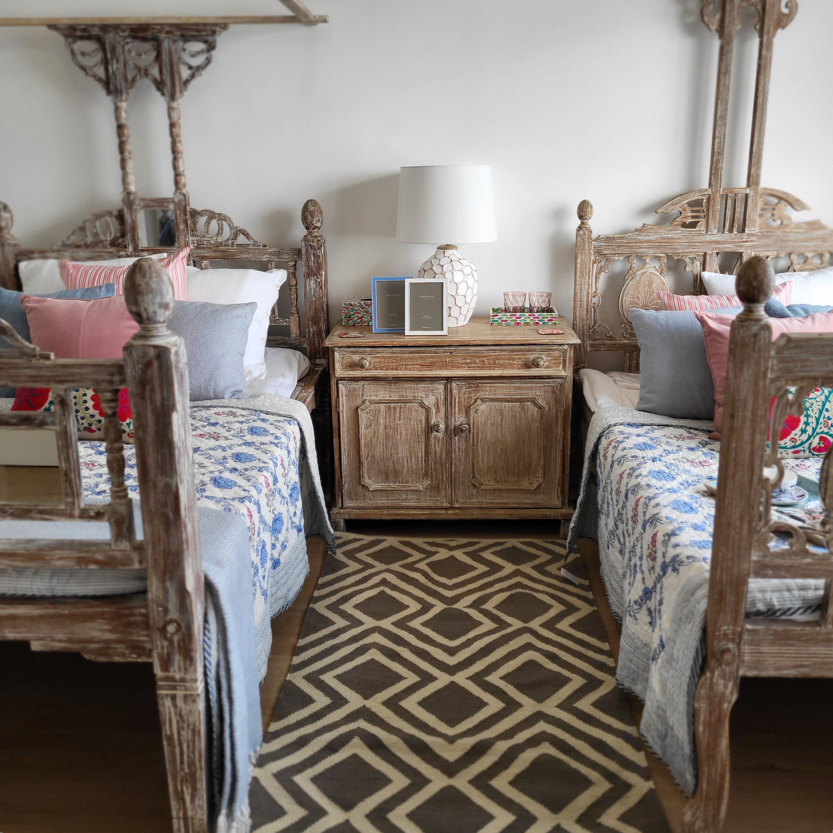 Teak canopy bed with a carved head and footboard, white wash