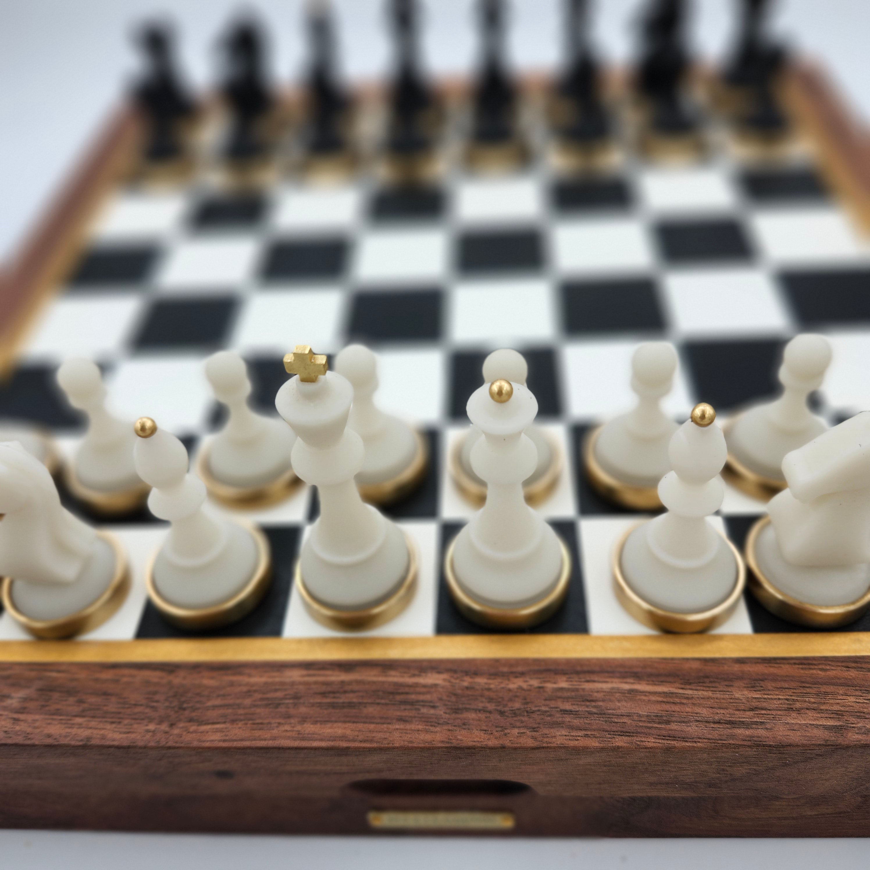 Luxury chess set with resin-concrete pieces and brass bases
