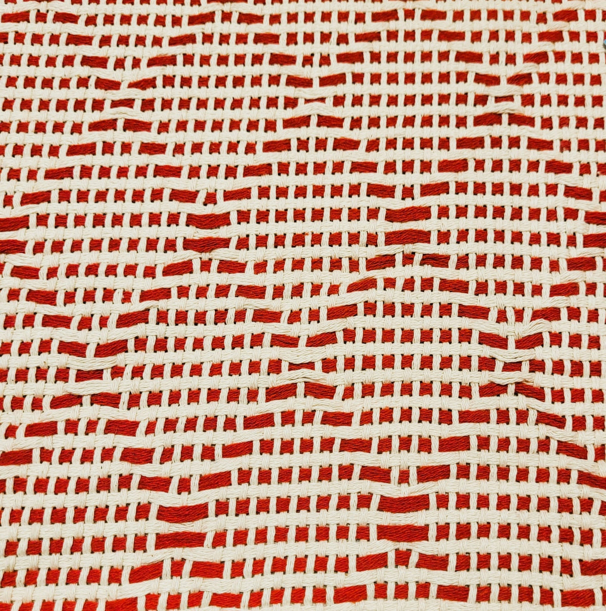 Close up of Portuguese mosaic recycled cotton throw in red