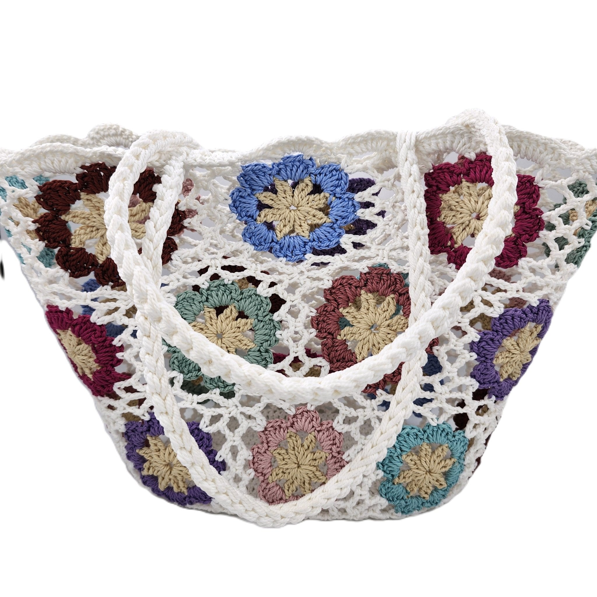 A white crocheted tote bag with colorful floral patterns, featuring thick white shoulder straps, shown against a plain white background.