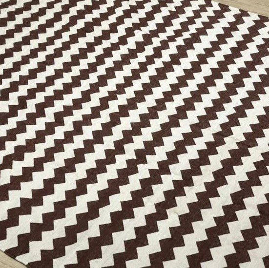 Cotton dhurry flat-woven rug with a brown and white zigzag pattern, 183 by 274 cm