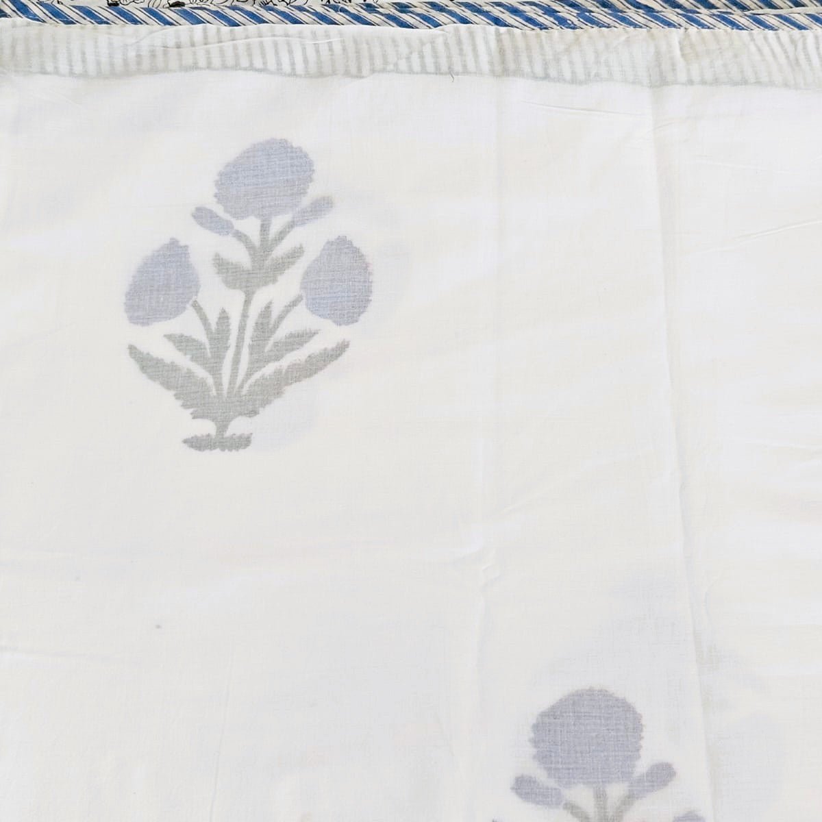 A block print dohar with a blue poppy design