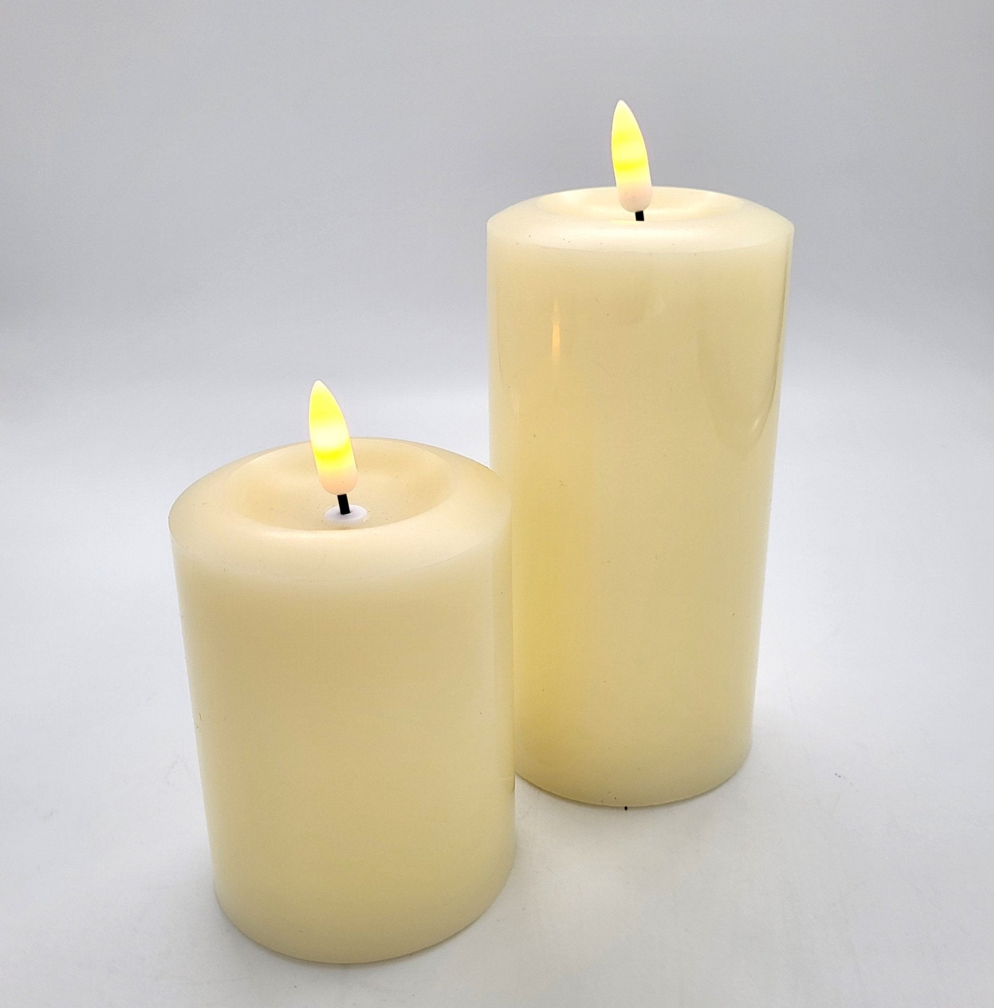 Flameless ivory pillar candles in three sizes, realistic battery-operated candles