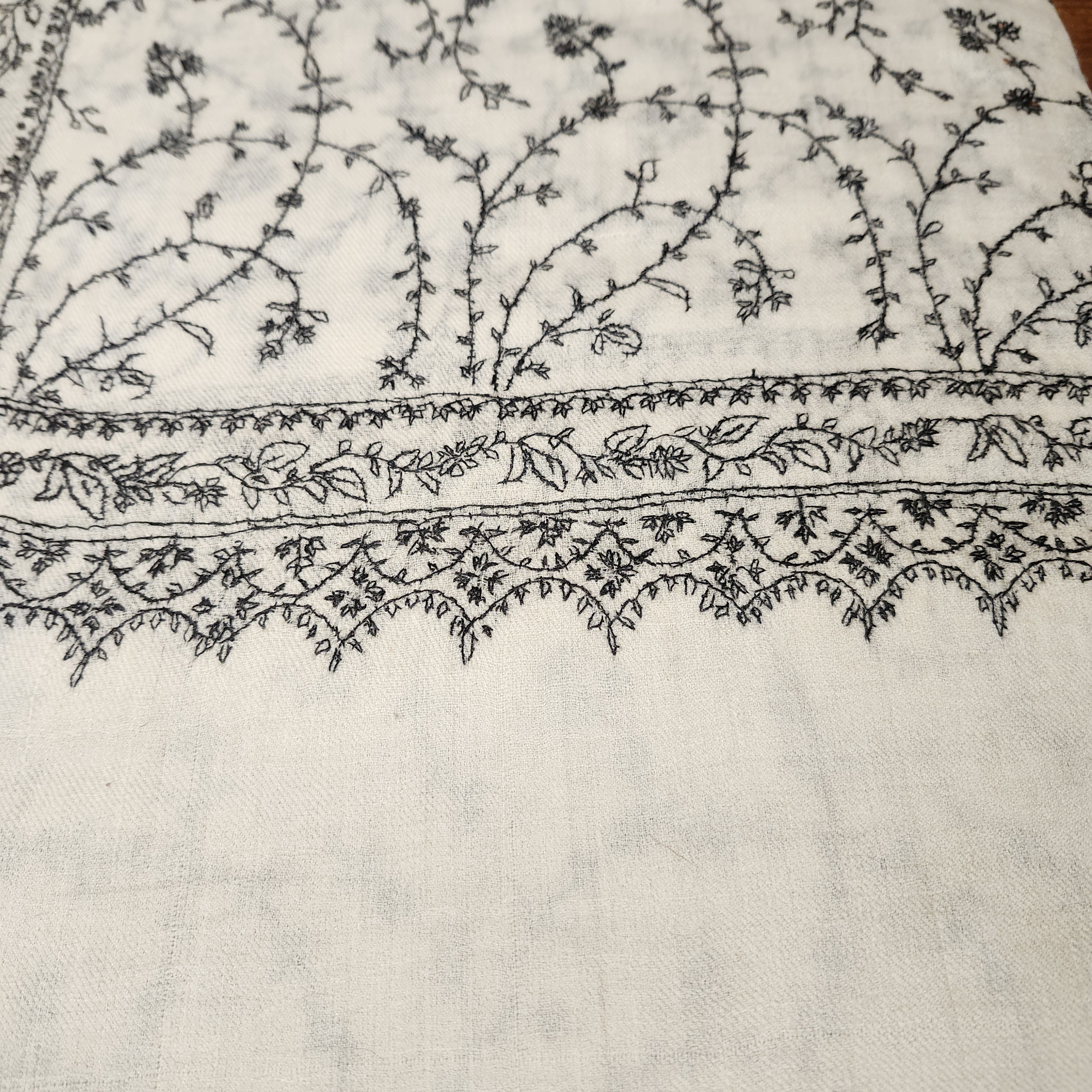 Creamy white pashmina with black floral hand embroidery, detail view