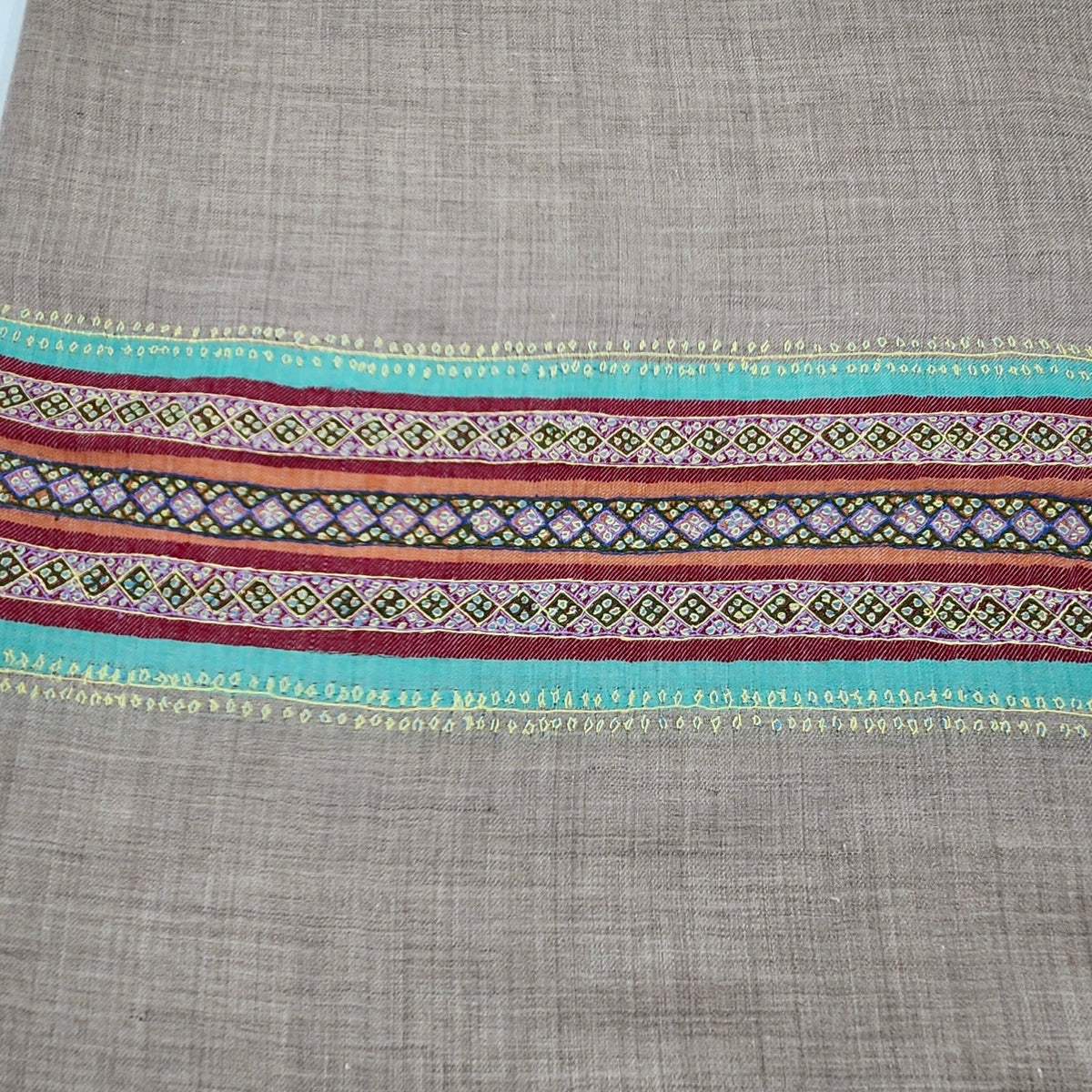 Multicoloured striped pashmina shawl with a deep hand-embroidered border in vibrant contrasting colours.