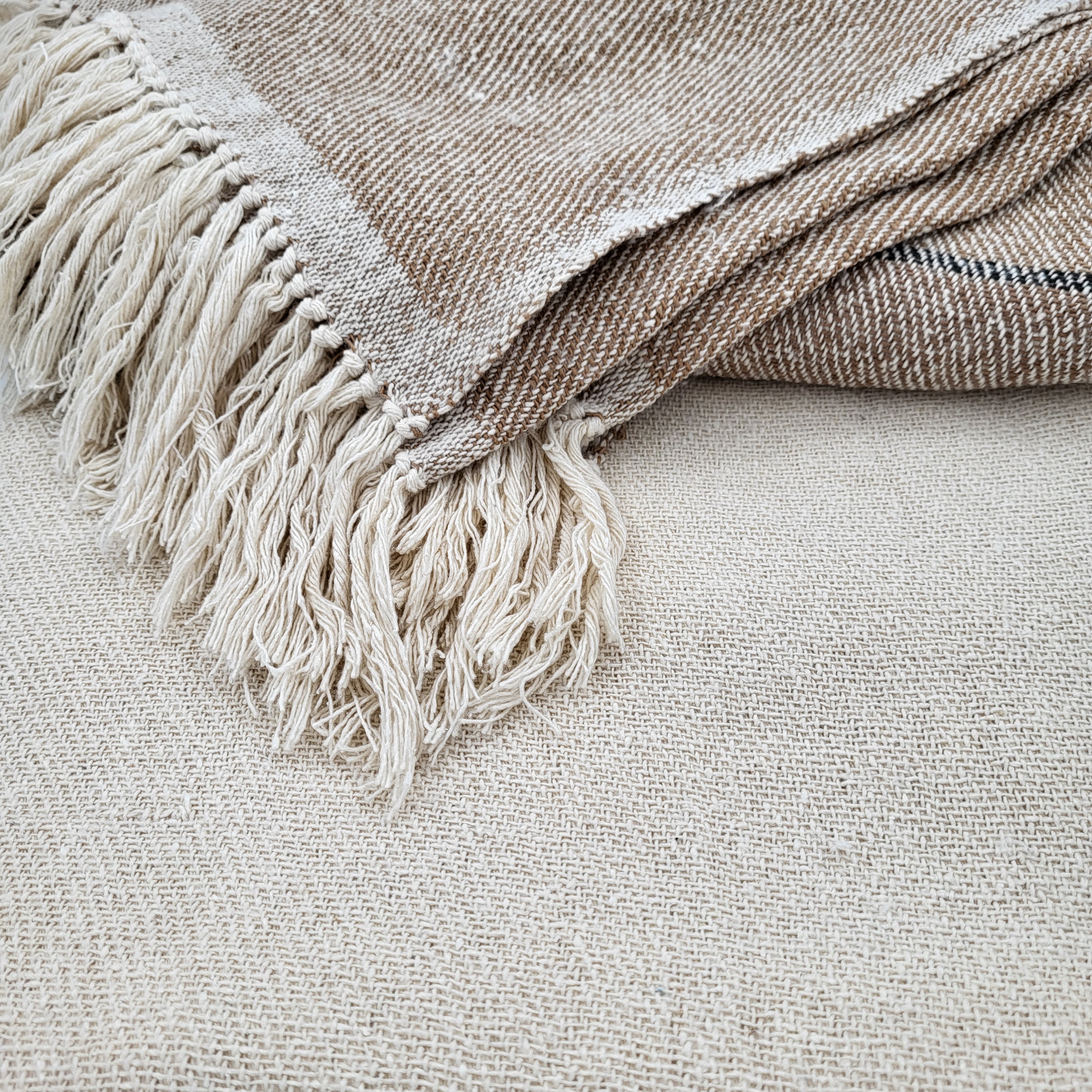 Cream silk handwoven throw with deep beige border, fringed