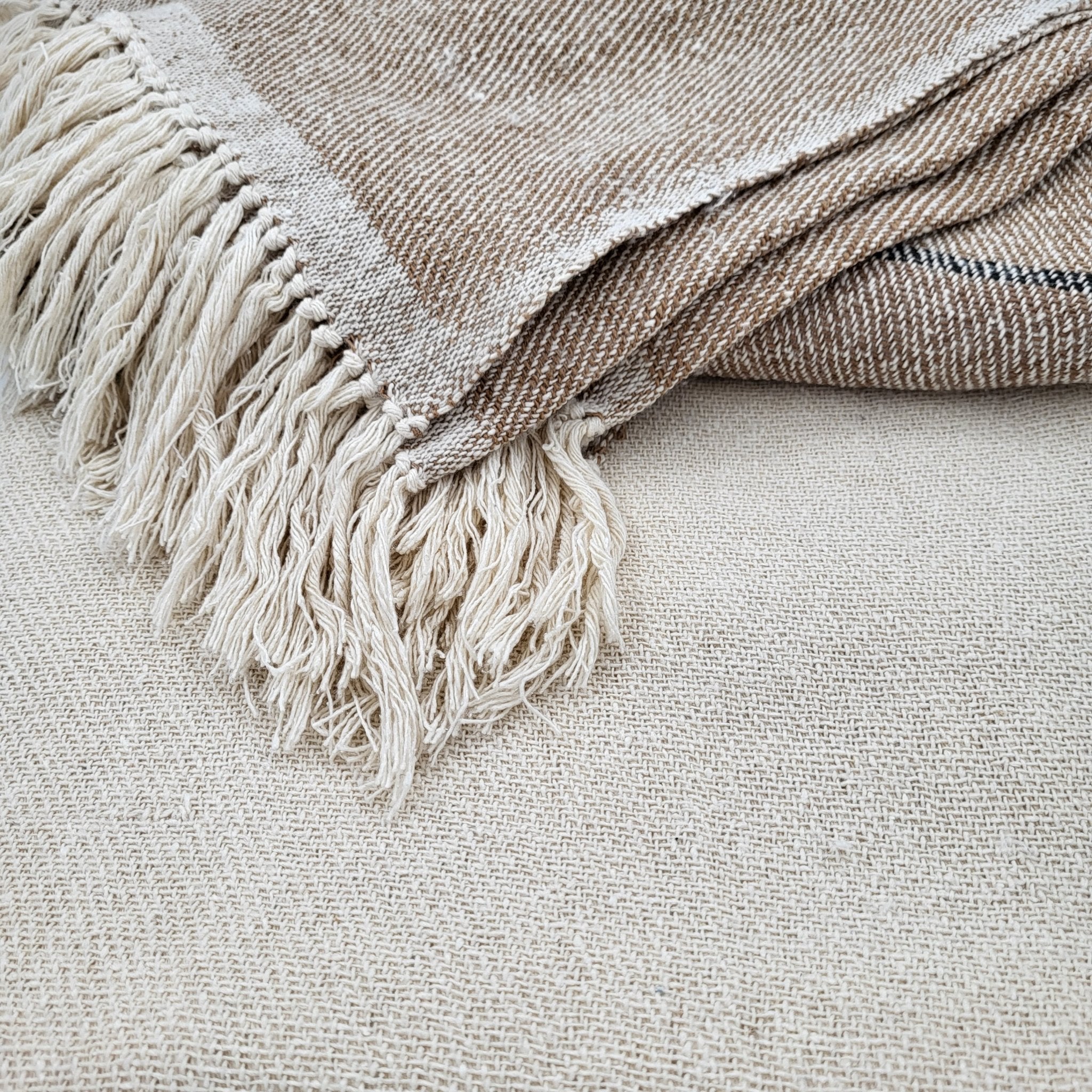 Cream silk handwoven throw with deep beige border, fringed