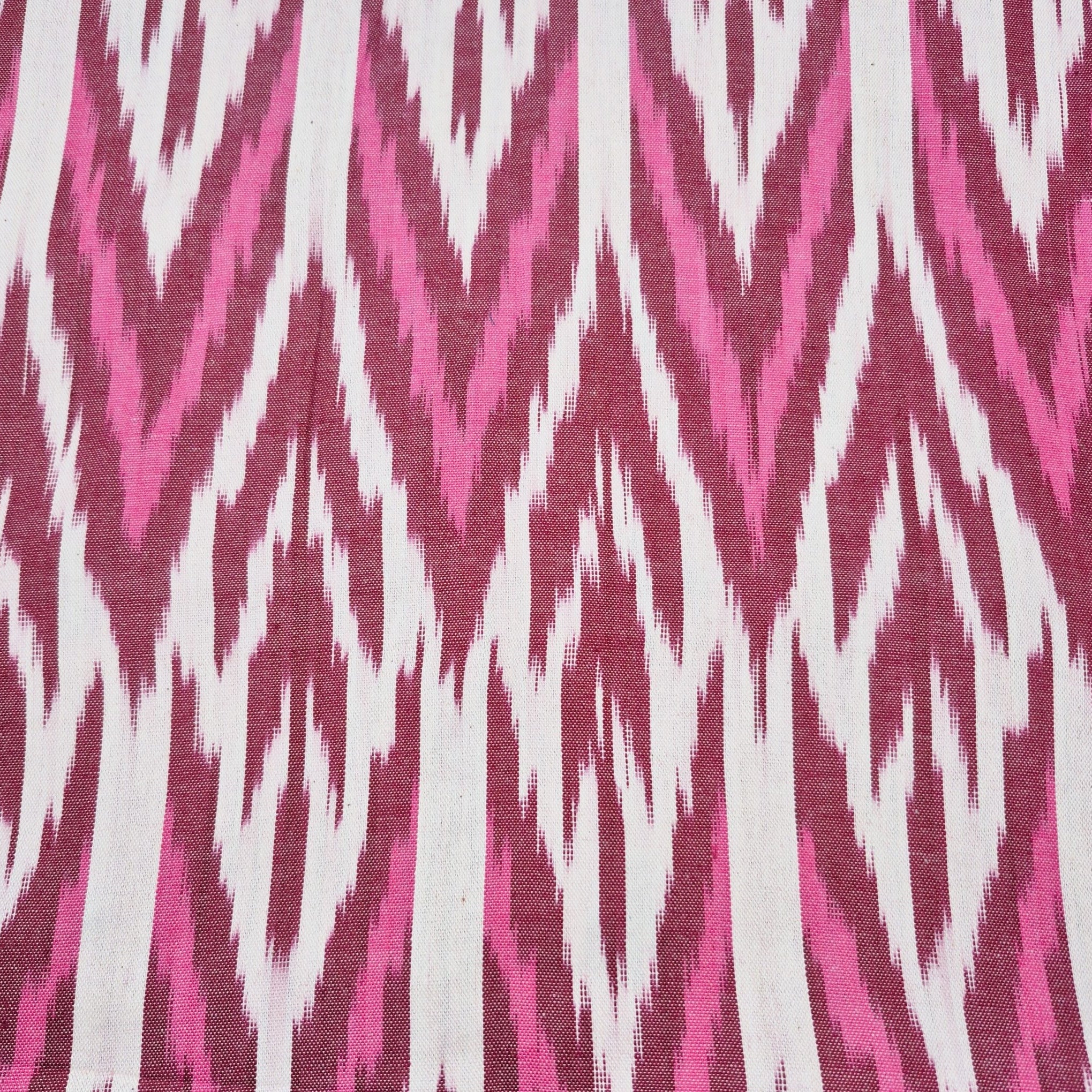 Ikat table runner with burgundy pink and white zigzag design