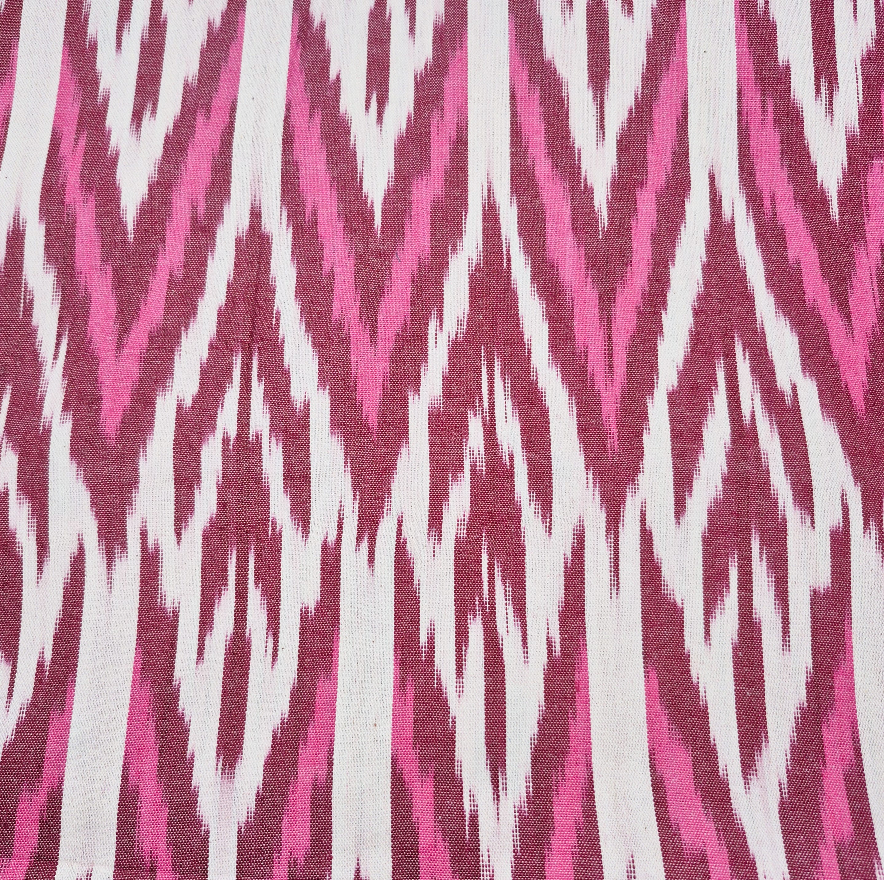 Ikat table runner with burgundy pink and white zigzag design
