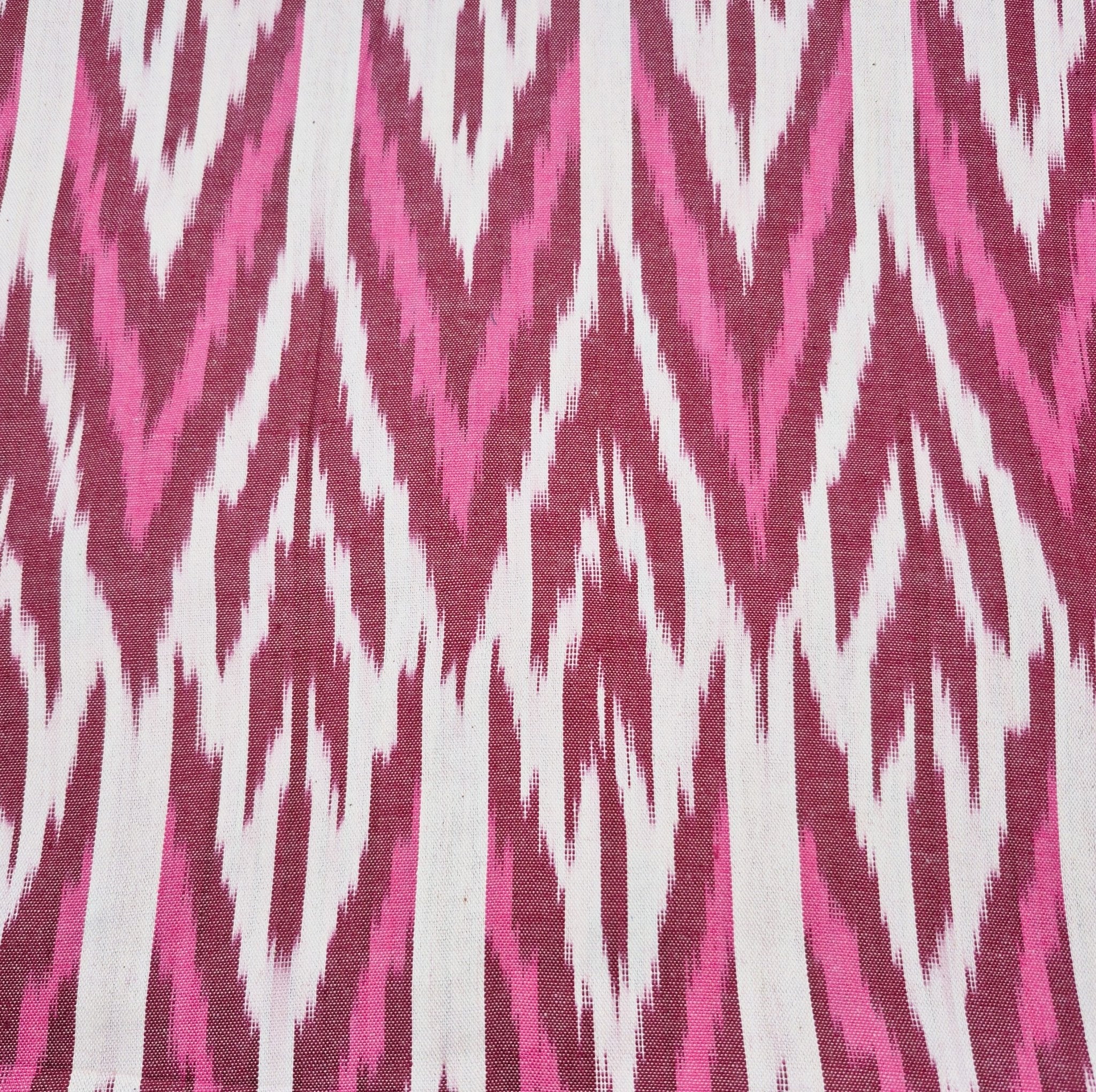 Ikat table runner with burgundy pink and white zigzag design