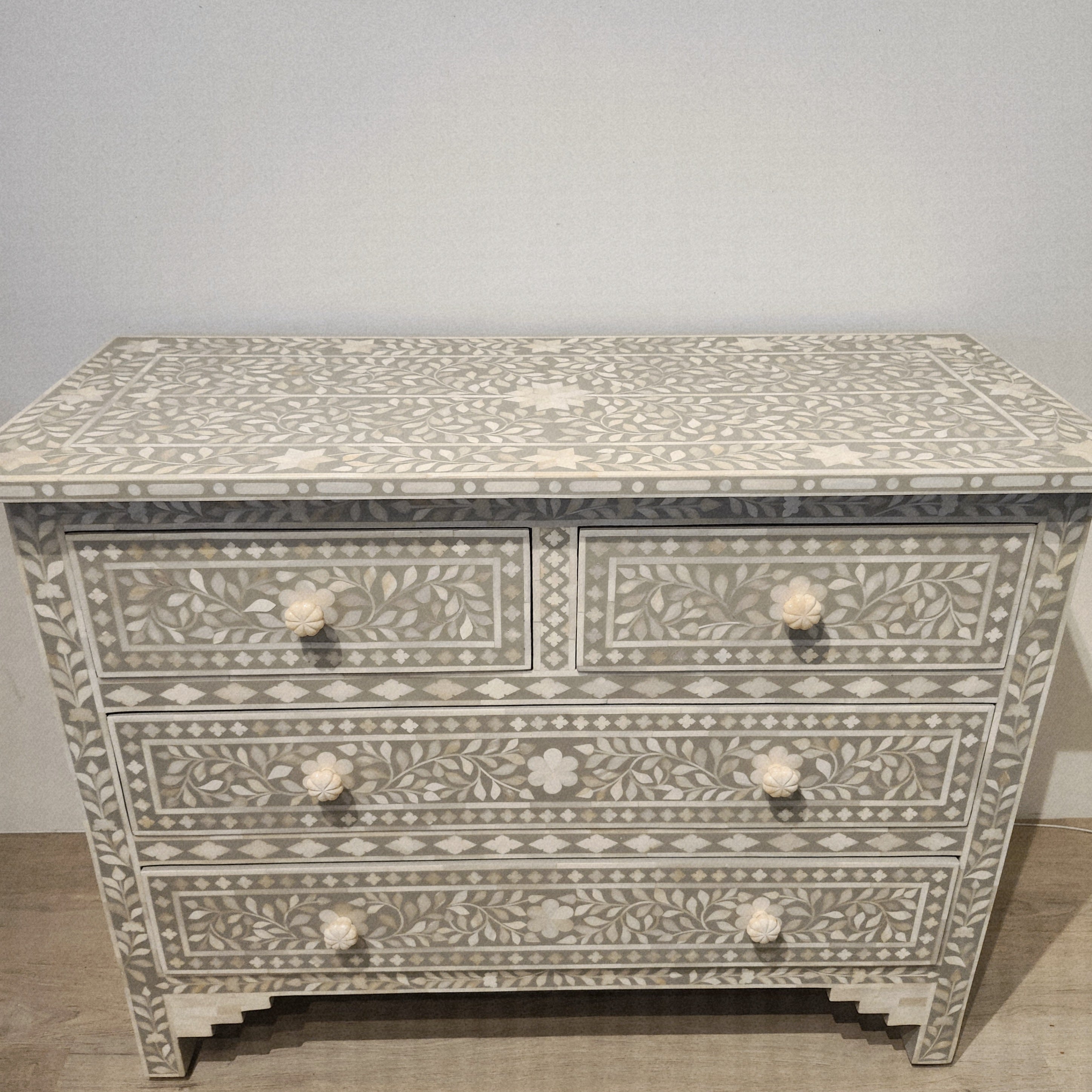 Taupe bone inlay chest with four drawers and carved bone knobs