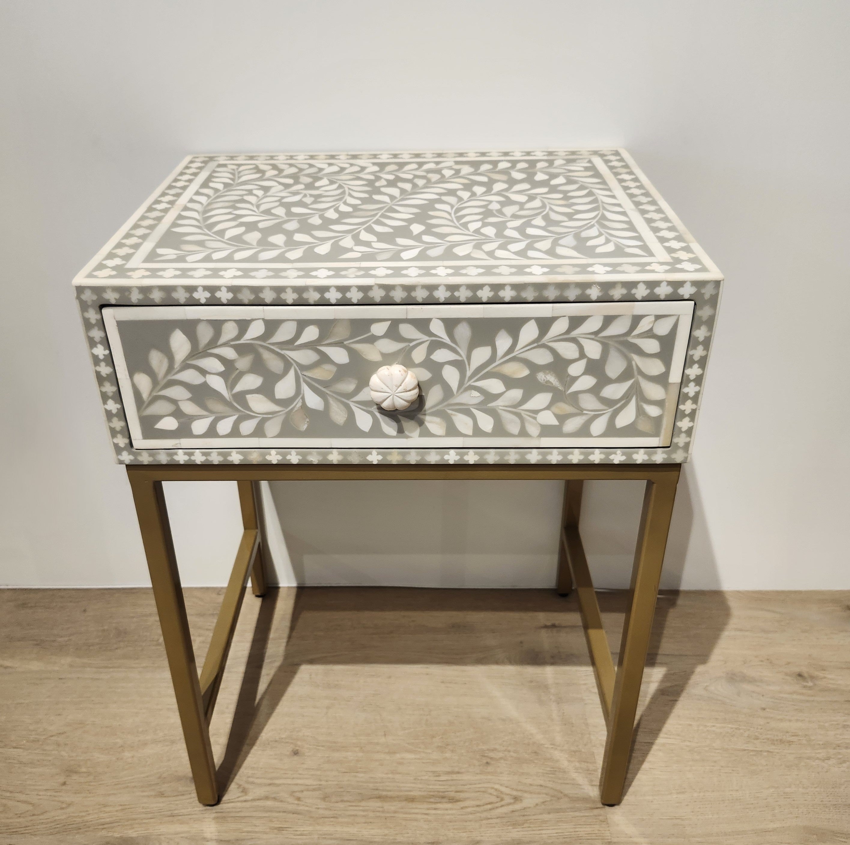 Bone inlay side table in taupe with a leaf design and metal frame