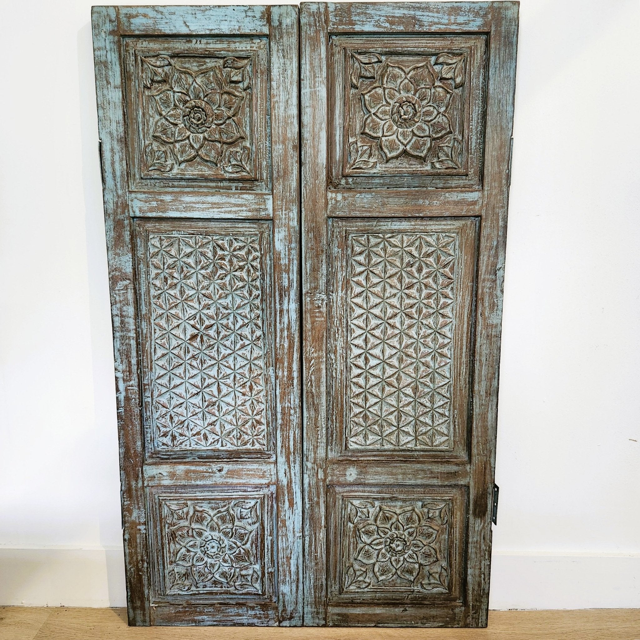 Pair of vintage Indian carved teak window shutters, distressed paint, 109 x 66cm