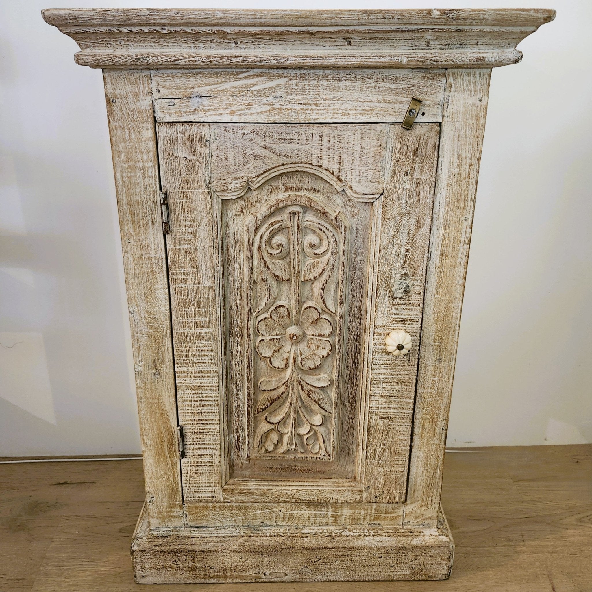 Vintage teak bedside table with carved floral door and bone handle, 66 x 45.7cm