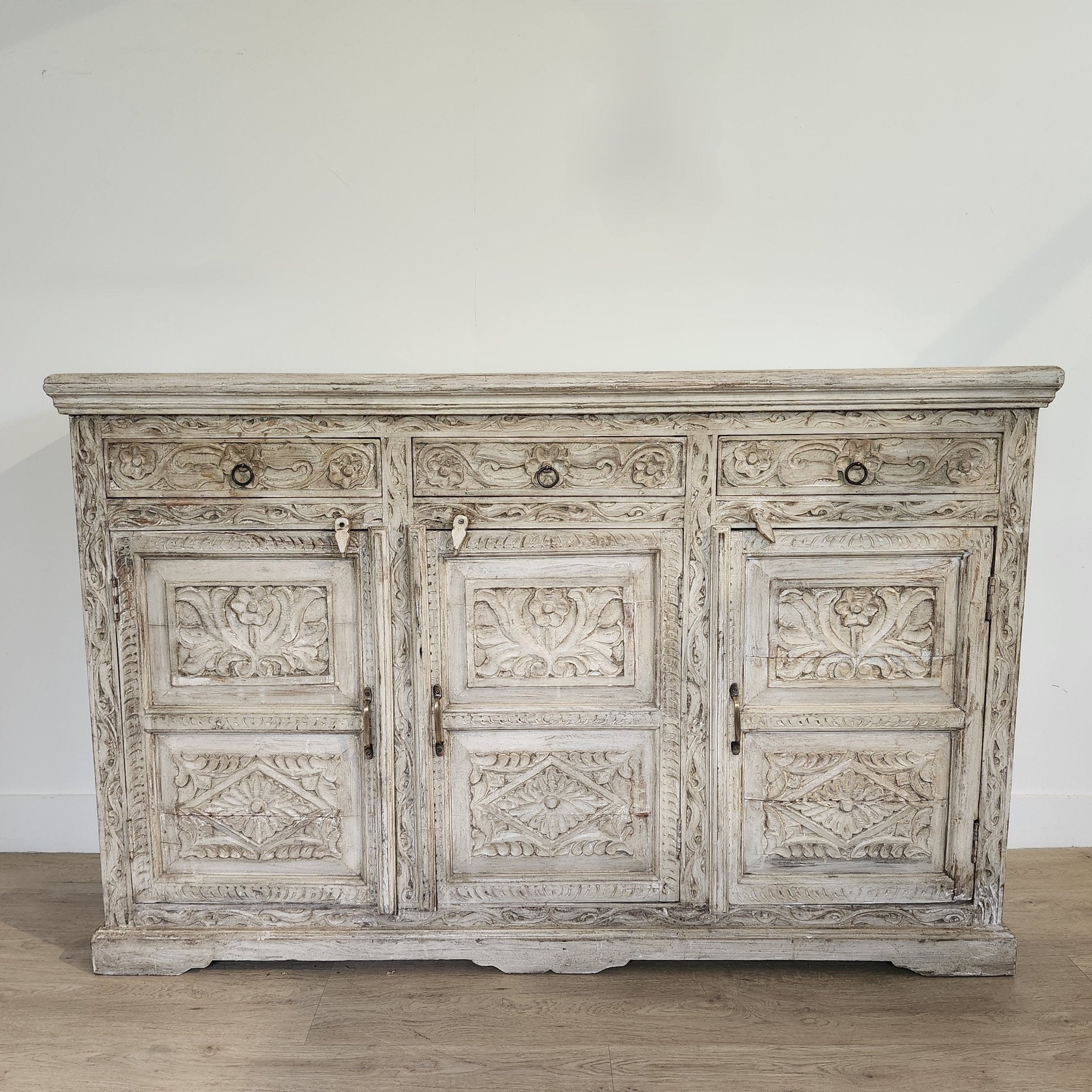 Hand-carved mango wood sideboard with three drawers and a limed finish