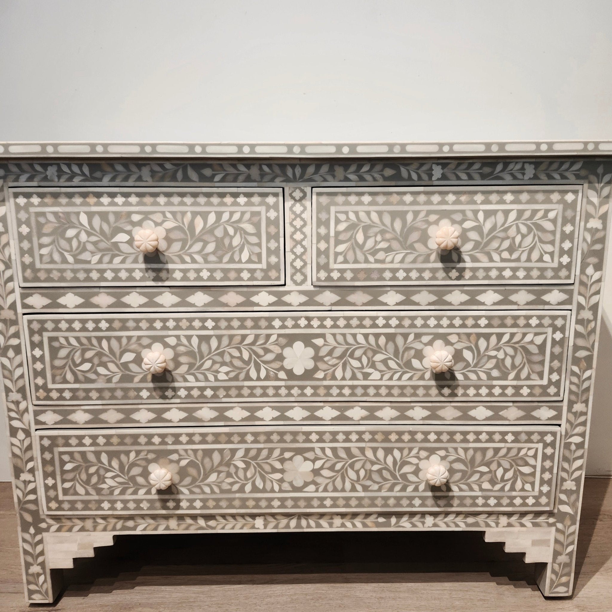 Bone inlay chest of drawers in taupe with a carved leaf design