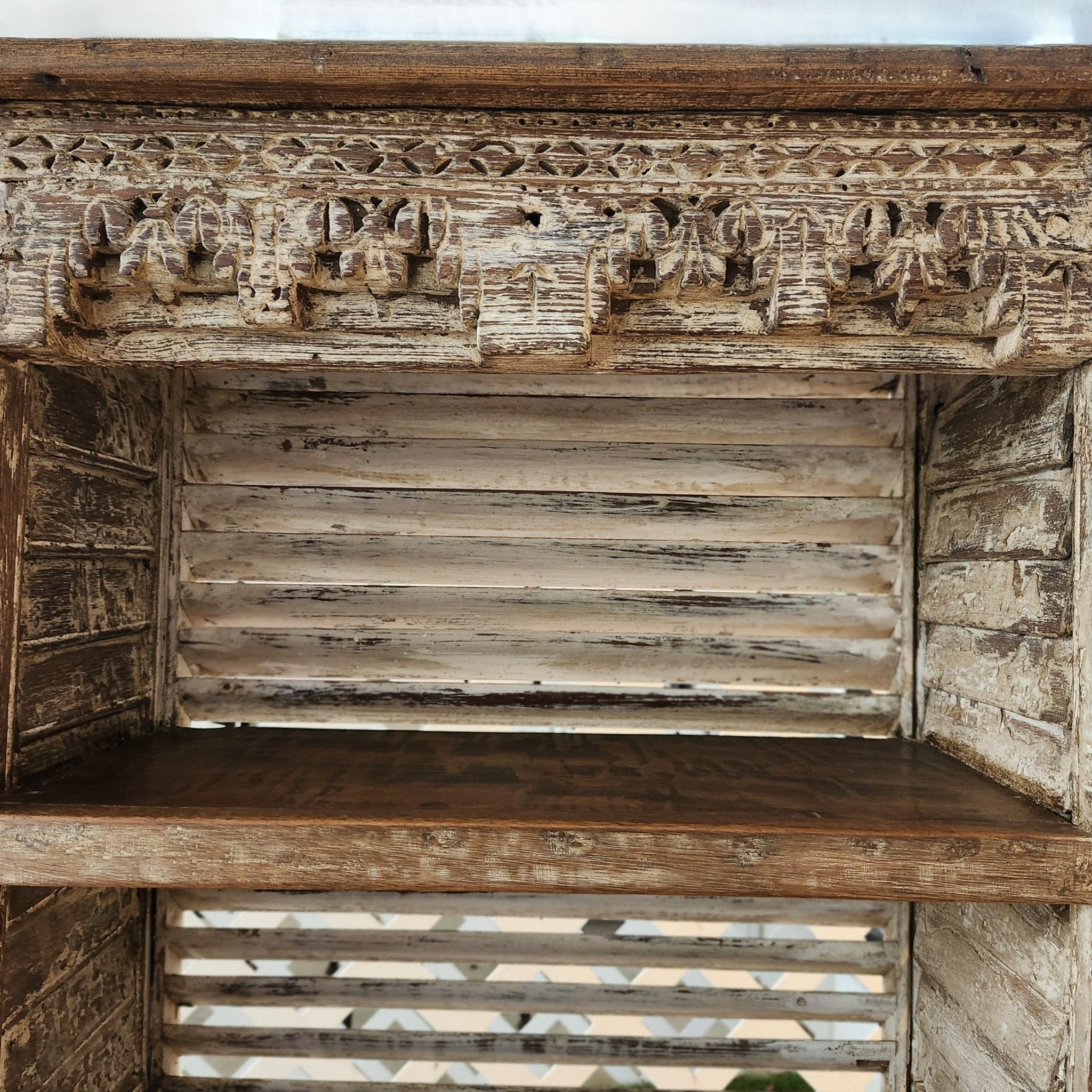 Distressed white teak shelving unit upcycled from old louvred shutters