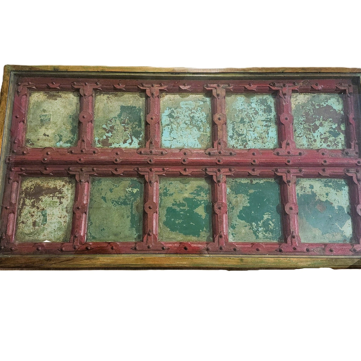 Old Rajasthani teak door painted red and pistachio, made into a coffee table with a solid glass top, 177cm wide by 95cm deep