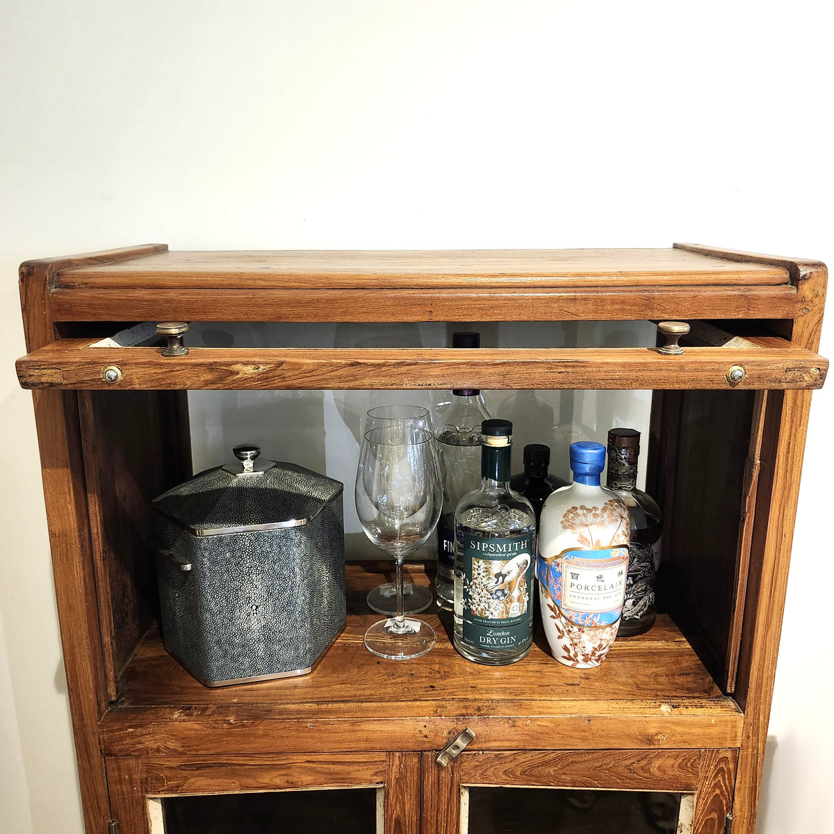Alternative view of the vintage teak drinks cabinet, its glazed top section with a flipper door, 40cm high and 60cm wide
