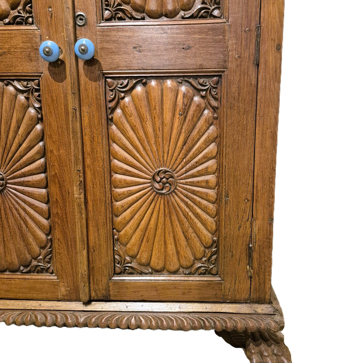 Carved teak cabinet with ceramic door knobs and two carved feet, 105 cm wide and 54 cm deep, from India